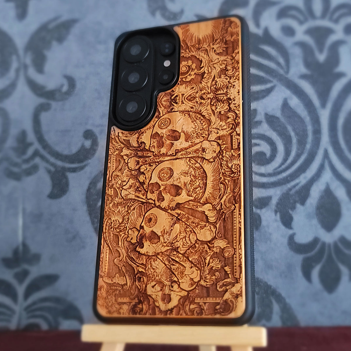 Cherrywood phone case with pile of skulls artwork and black TPU protective frame
