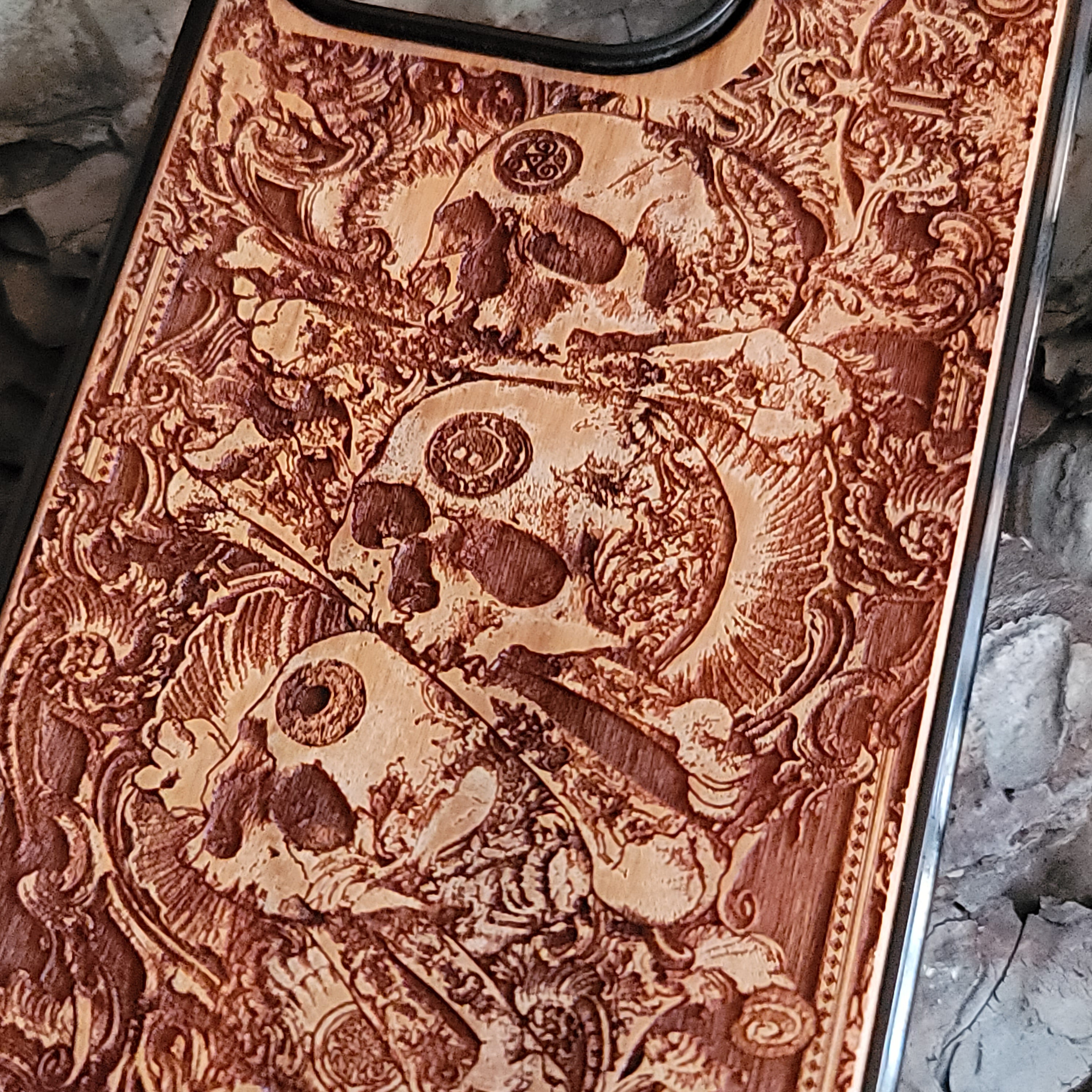 Handcrafted wooden phone case with detailed skull engravings inspired by medieval church architecture, compatible with iPhone , iPhone 15, iPhone 14, iPhone 13, iPhone 12, iPhone 11 Pro Max, iPhone 11 Mini, Samsung Galaxy S, S24, S23, S22, S21, S20 Ultra Plus, and Note 20.