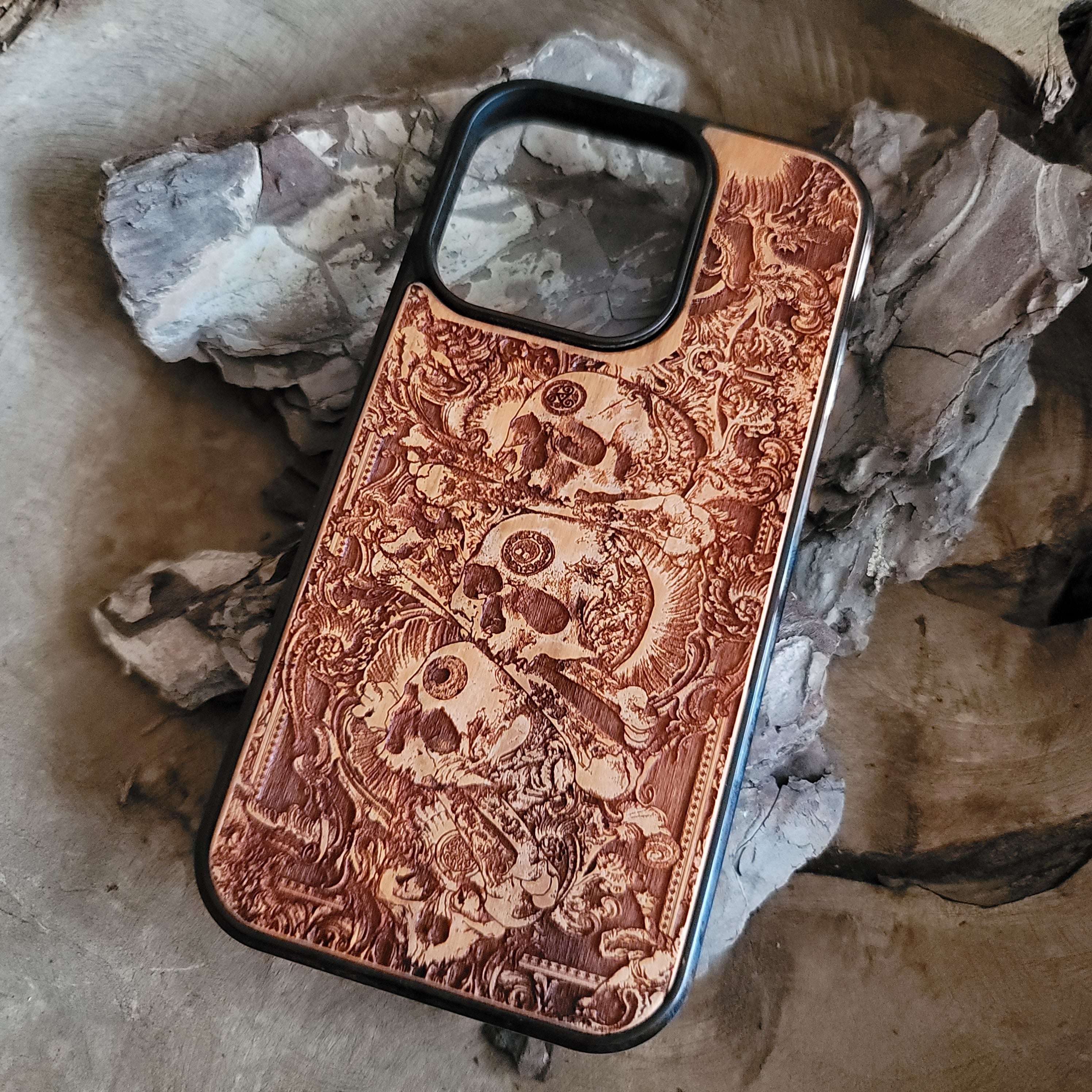 Handcrafted wooden phone case with detailed skull engravings inspired by medieval church architecture, compatible with iPhone , iPhone 15, iPhone 14, iPhone 13, iPhone 12, iPhone 11 Pro Max, iPhone 11 Mini, Samsung Galaxy S, S24, S23, S22, S21, S20 Ultra Plus, and Note 20.
