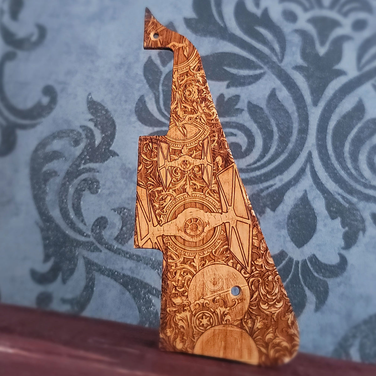 Handcrafted wood guitar scratchplate featuring detailed starfighters and futuristic space symbols