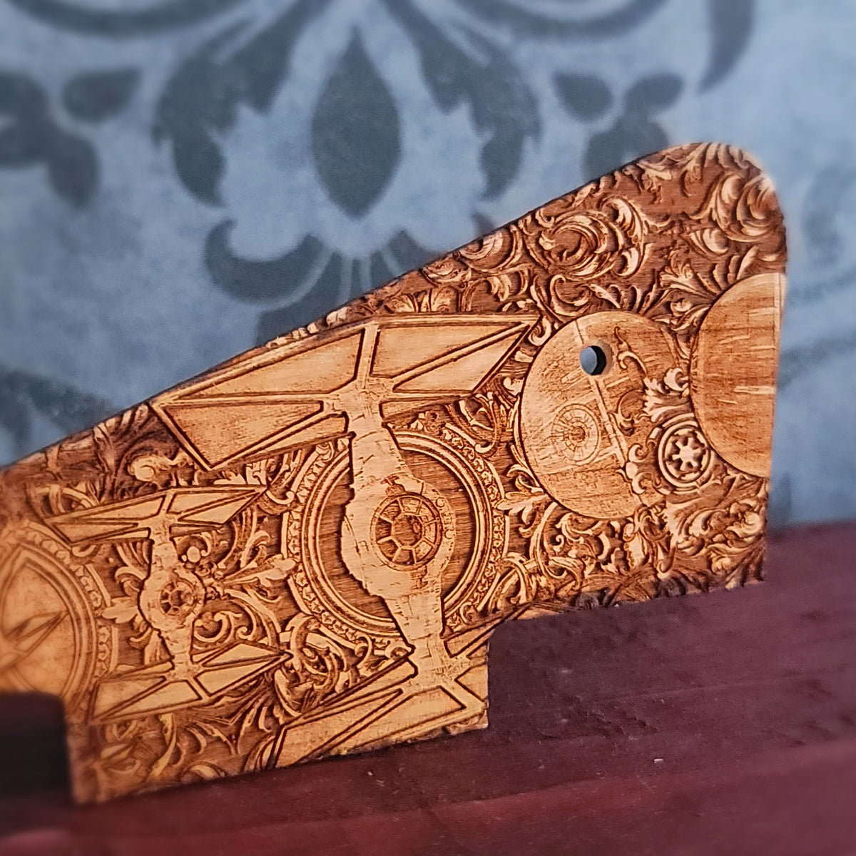 Close up of sci fi space battle engraving on cherry wood pickguard for Les Paul style guitar