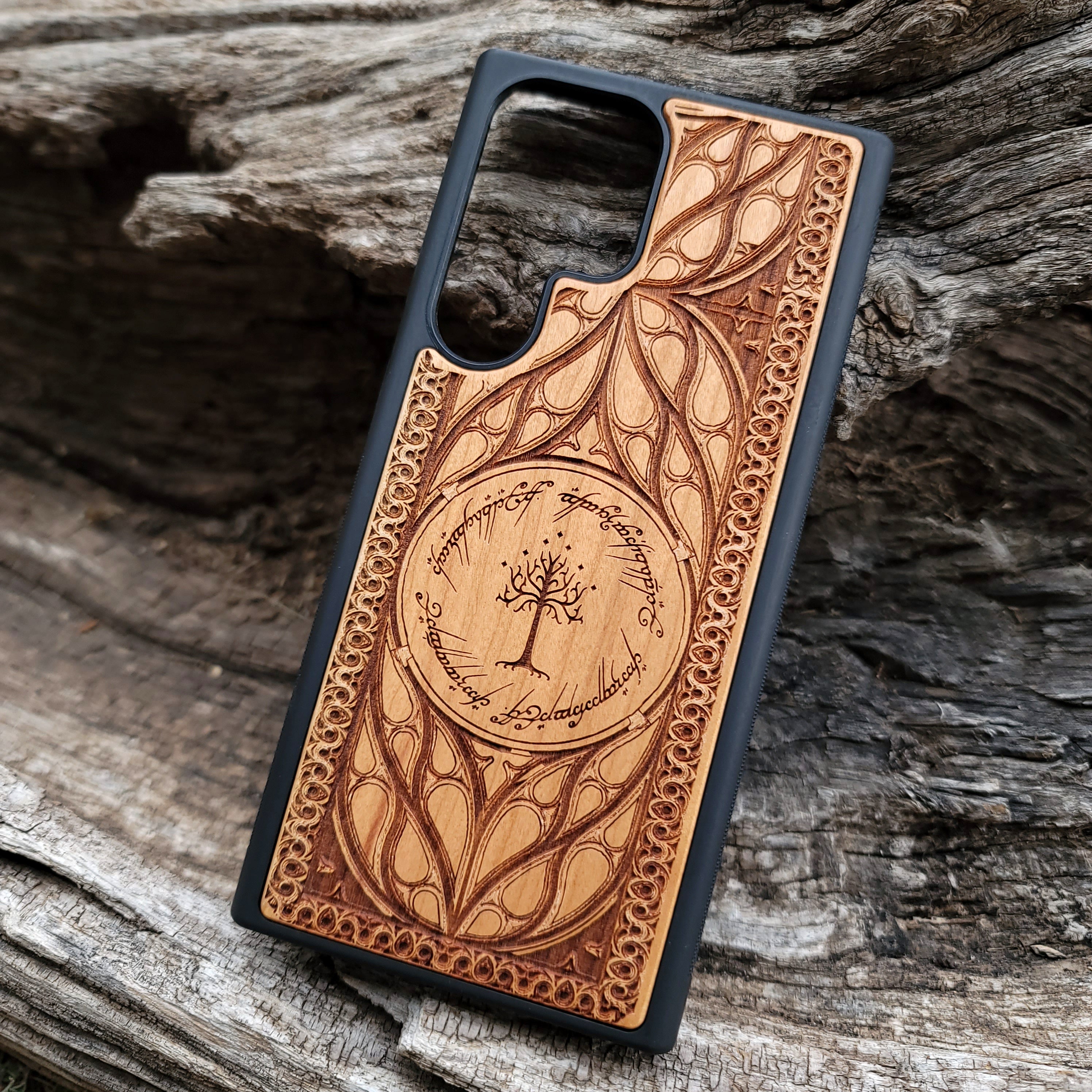 "Lord of the Rings White Tree of Gondor wood phone case, laser-engraved with intricate Elvish script and decorative patterns. This durable and protective case is compatible with iPhone , 15, 14, 13, 12, 11, Pro Max, Mini, and Samsung Galaxy S, S24, S23, S22, S21, S20 Ultra, Plus, Note 20. Elegant, slim, and perfect for Tolkien fans seeking a unique phone accessory."