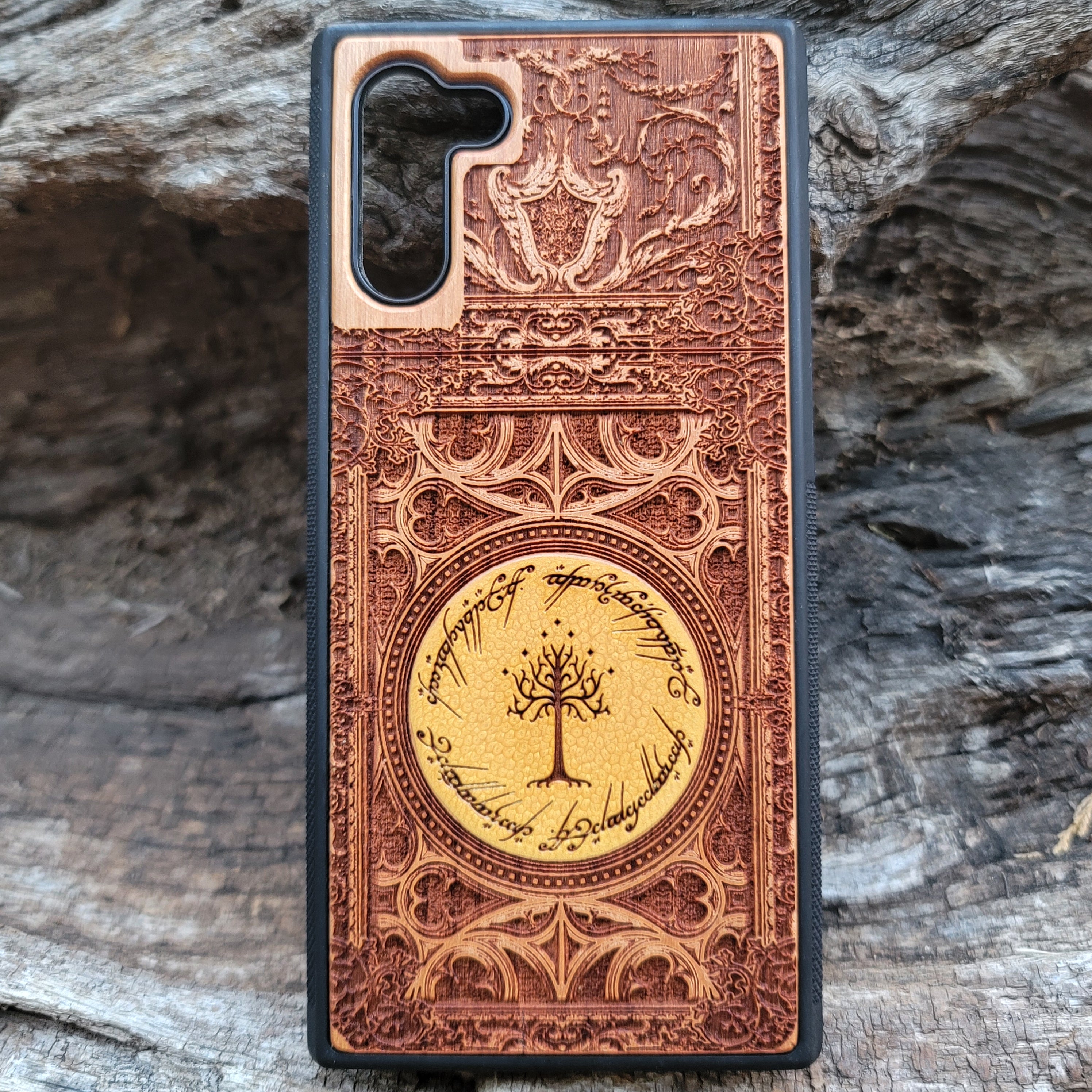 Lord of the Rings Gothic wood phone case featuring intricate laser-engraved designs inspired by Tolkien's Middle-Earth. The design includes Elvish script and Gothic elements, creating a dramatic, elegant look. Compatible with iPhone , 15, 14, 13, 12, 11 Pro Max Mini and Samsung Galaxy S, S24, S23, S22, S21, S20 Ultra, Plus, and Note 20. A stylish, durable, and unique accessory for LOTR fans.