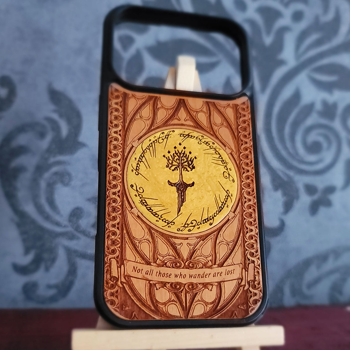 Lord of the Rings wood phone case featuring a stunning laser-engraved Tolkien design with intricate Elvish script and detailed patterns.