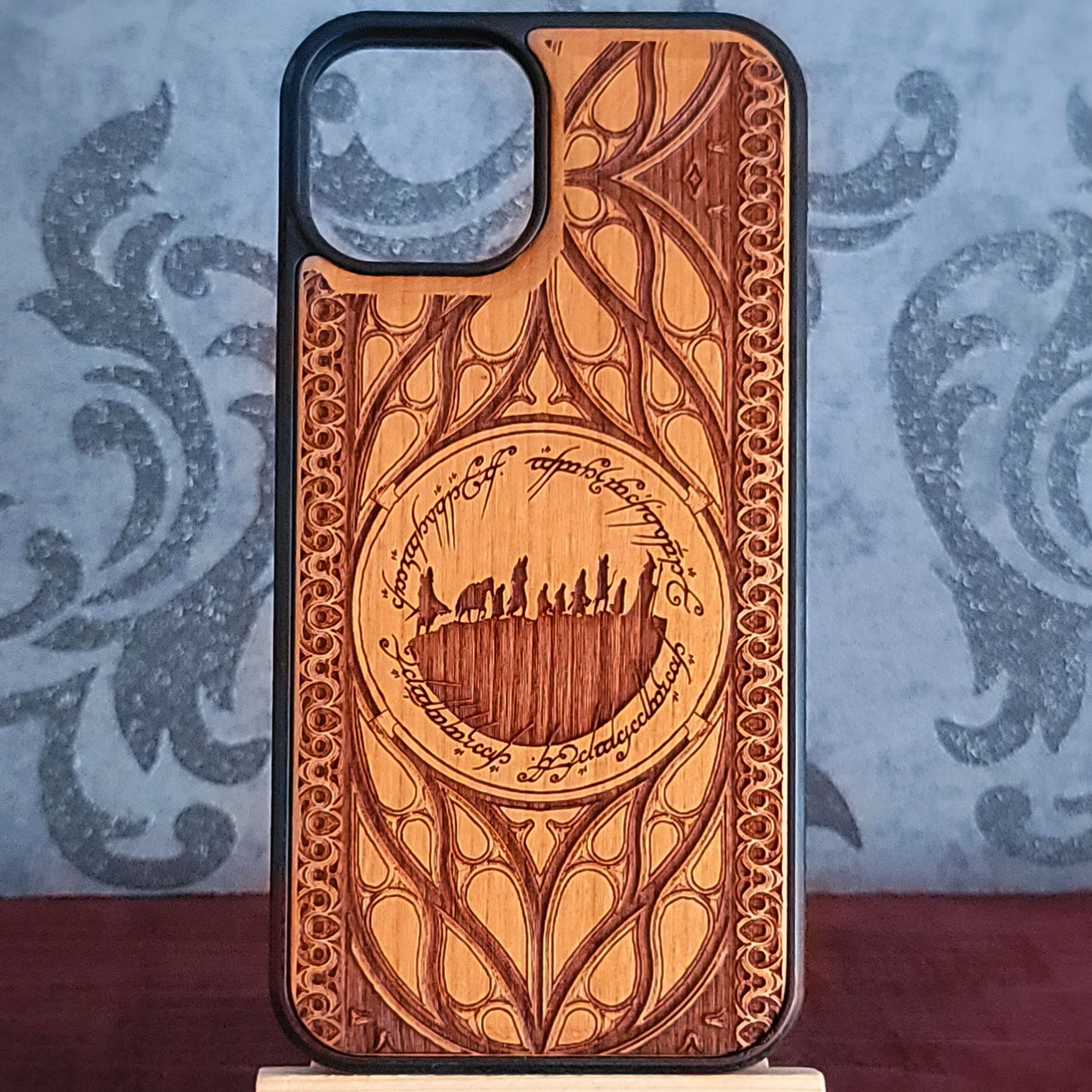 Lord of the Rings wood phone case featuring the Fellowship of the Ring silhouette surrounded by Elvish script and intricate, elegant patterns.