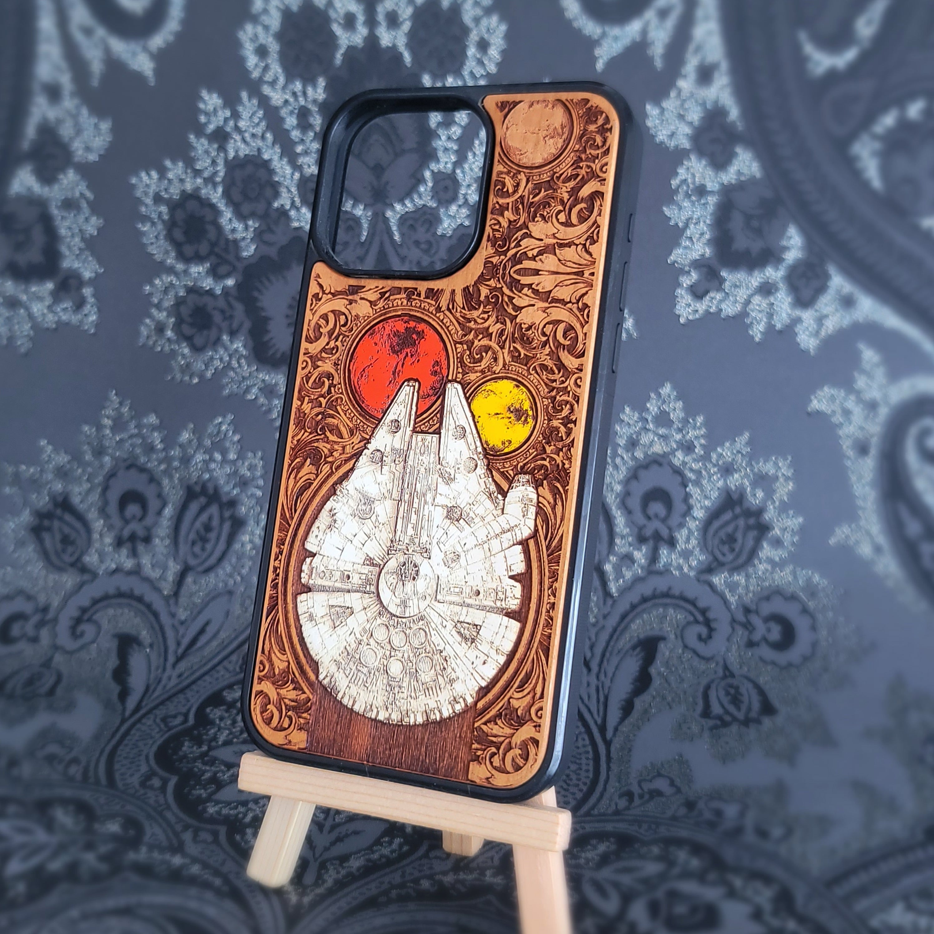 Deep laser engraved wooden phone case featuring a detailed sci-fi smuggler spaceship inspired by classic space adventure movies for iPhone and Samsung Galaxy models.