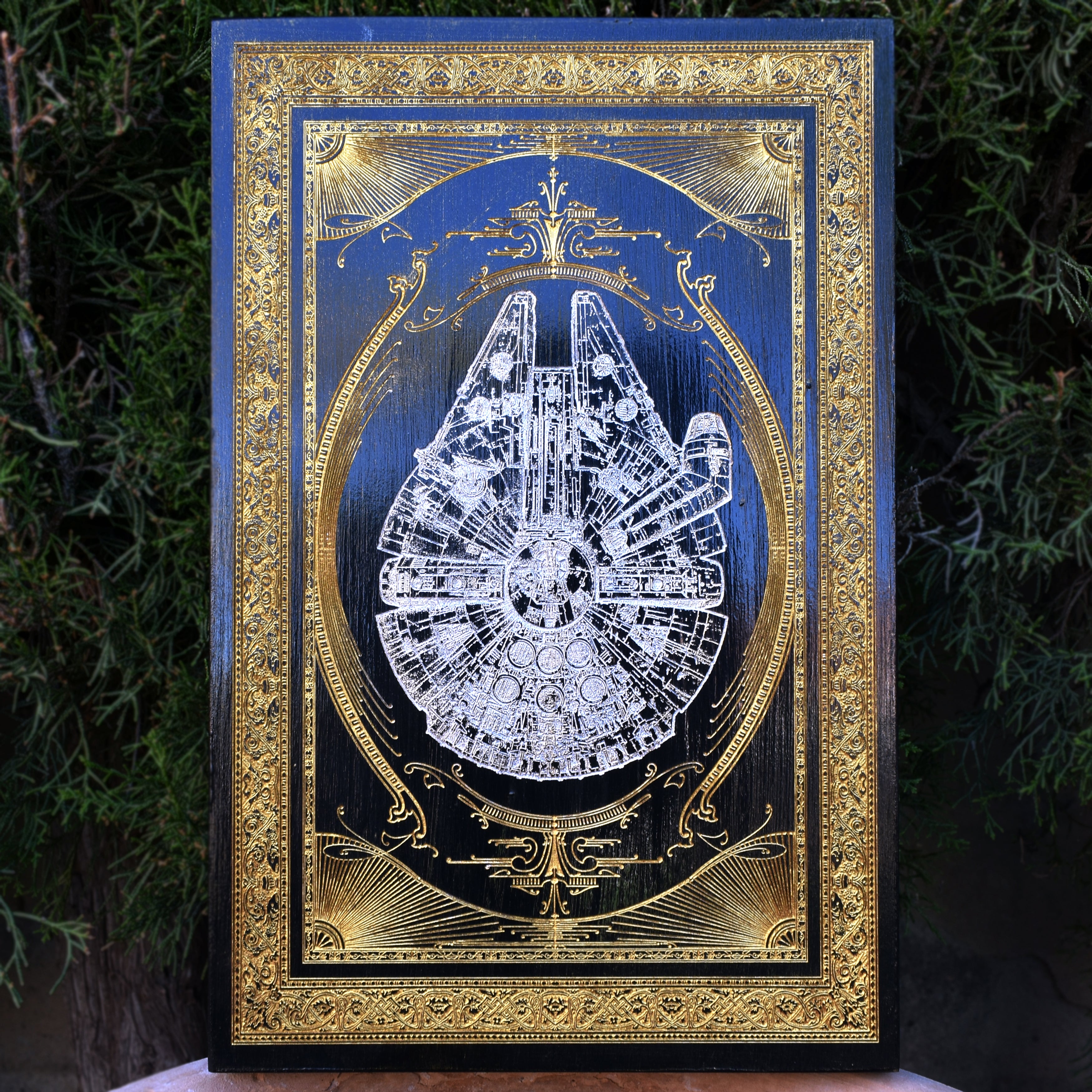 Laser-engraved Millennium Falcon wood art, perfect for Star Wars fans.