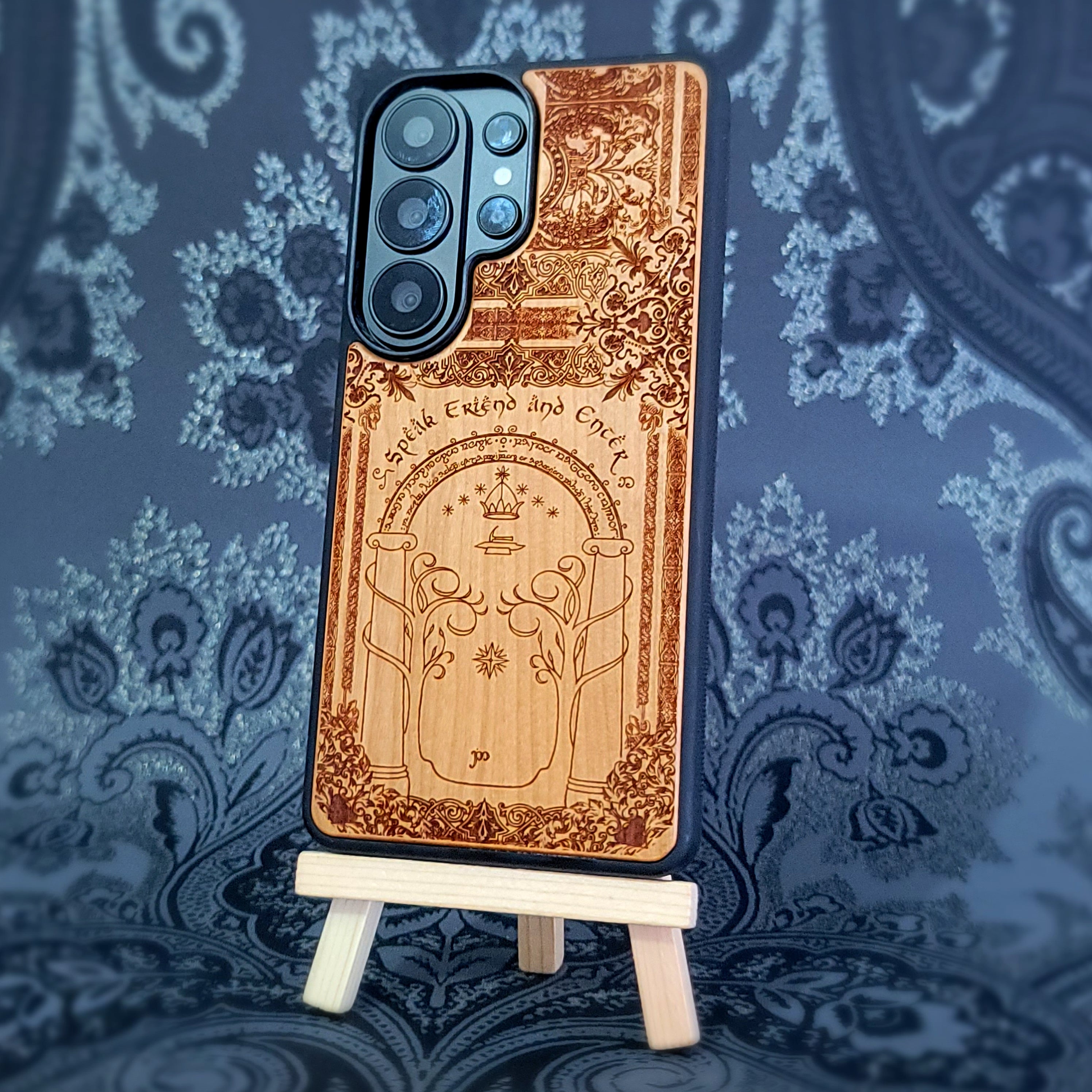 Deep laser engraved wooden phone case featuring a fantasy gate inspired by the Gates of Moria on natural wood for iPhone and Samsung Galaxy models.