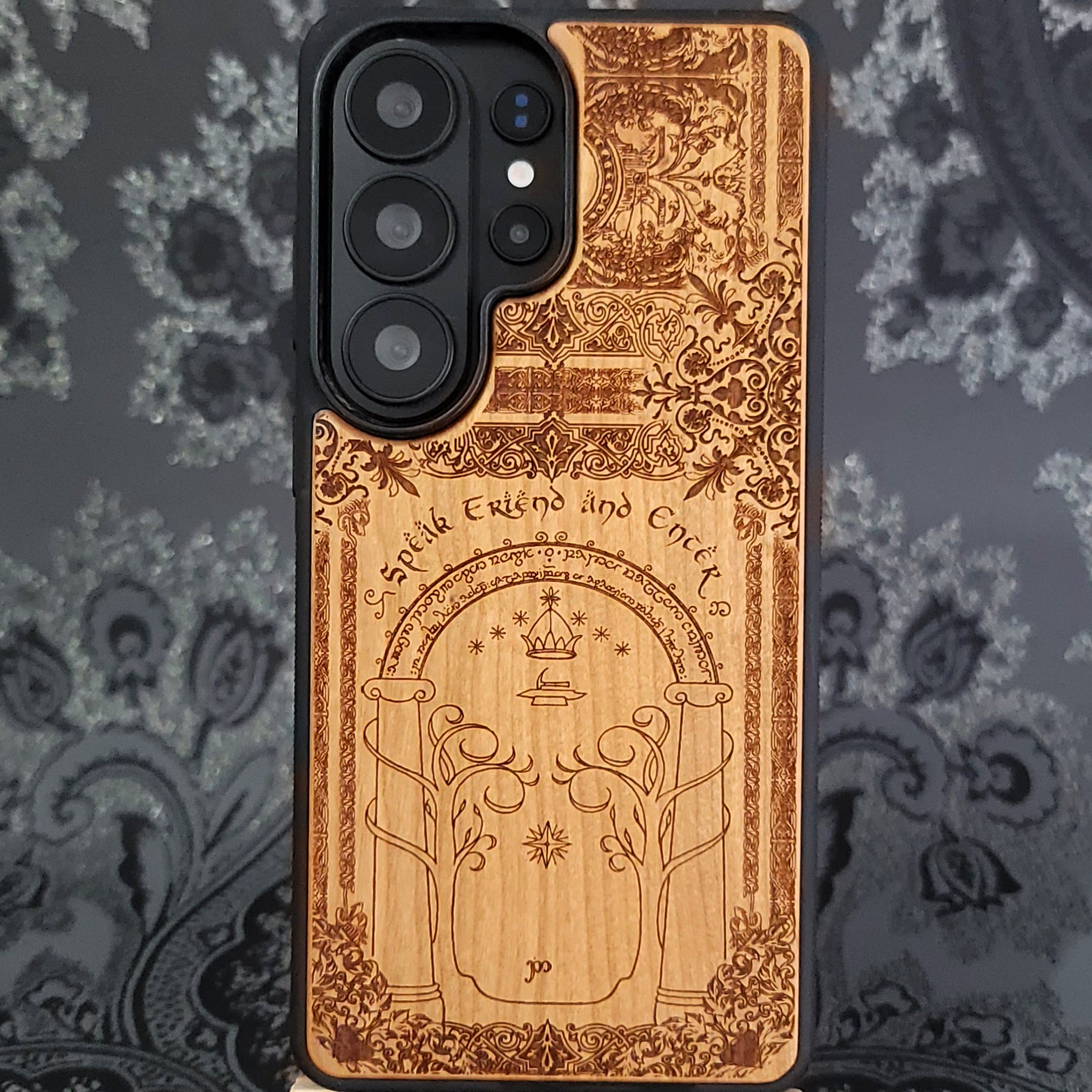 Deep laser engraved wooden phone case featuring a fantasy gate inspired by the Gates of Moria on natural wood for iPhone and Samsung Galaxy models.