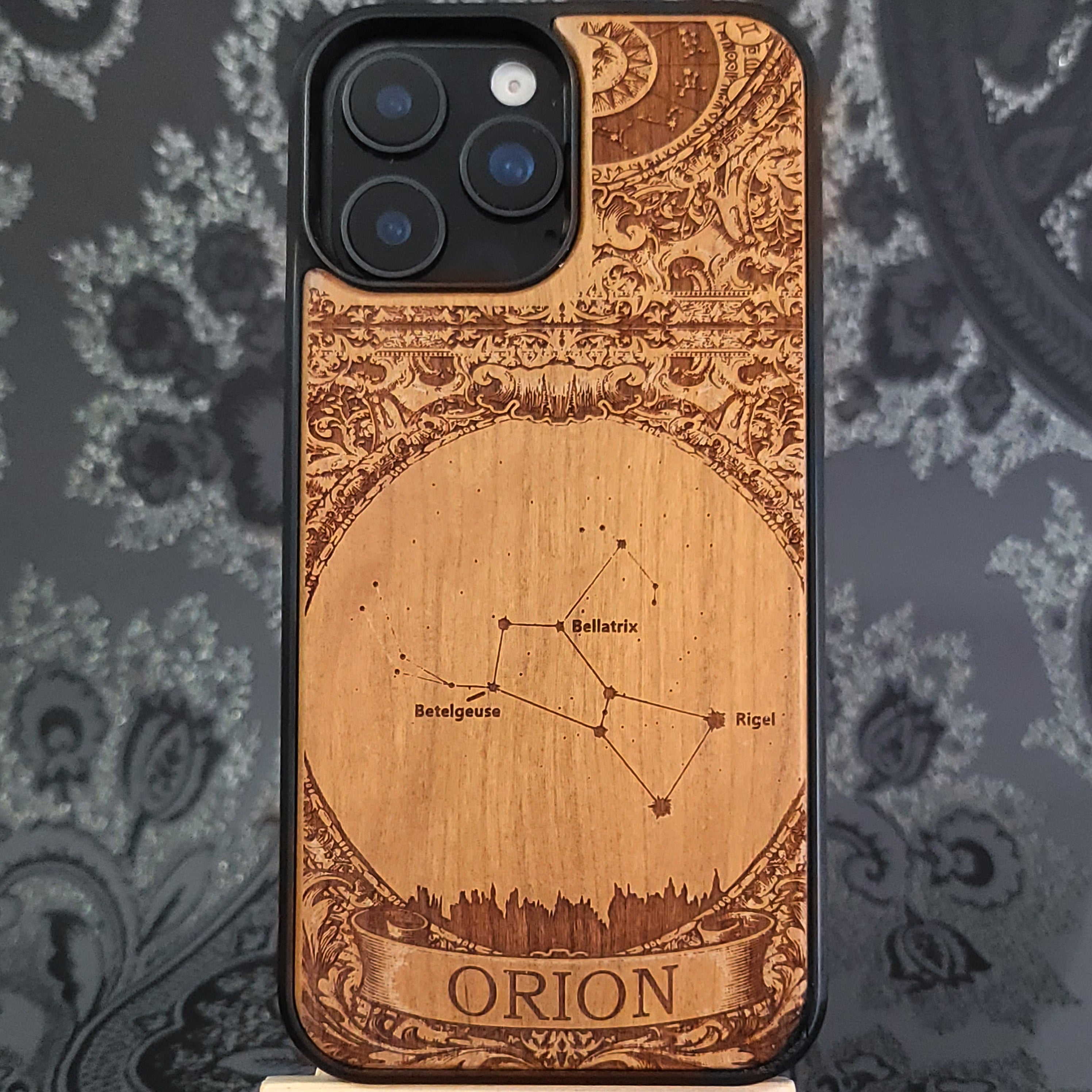 laser engraved wooden phone case featuring the Orion constellation with celestial star details on natural wood for iPhone and Samsung Galaxy models.