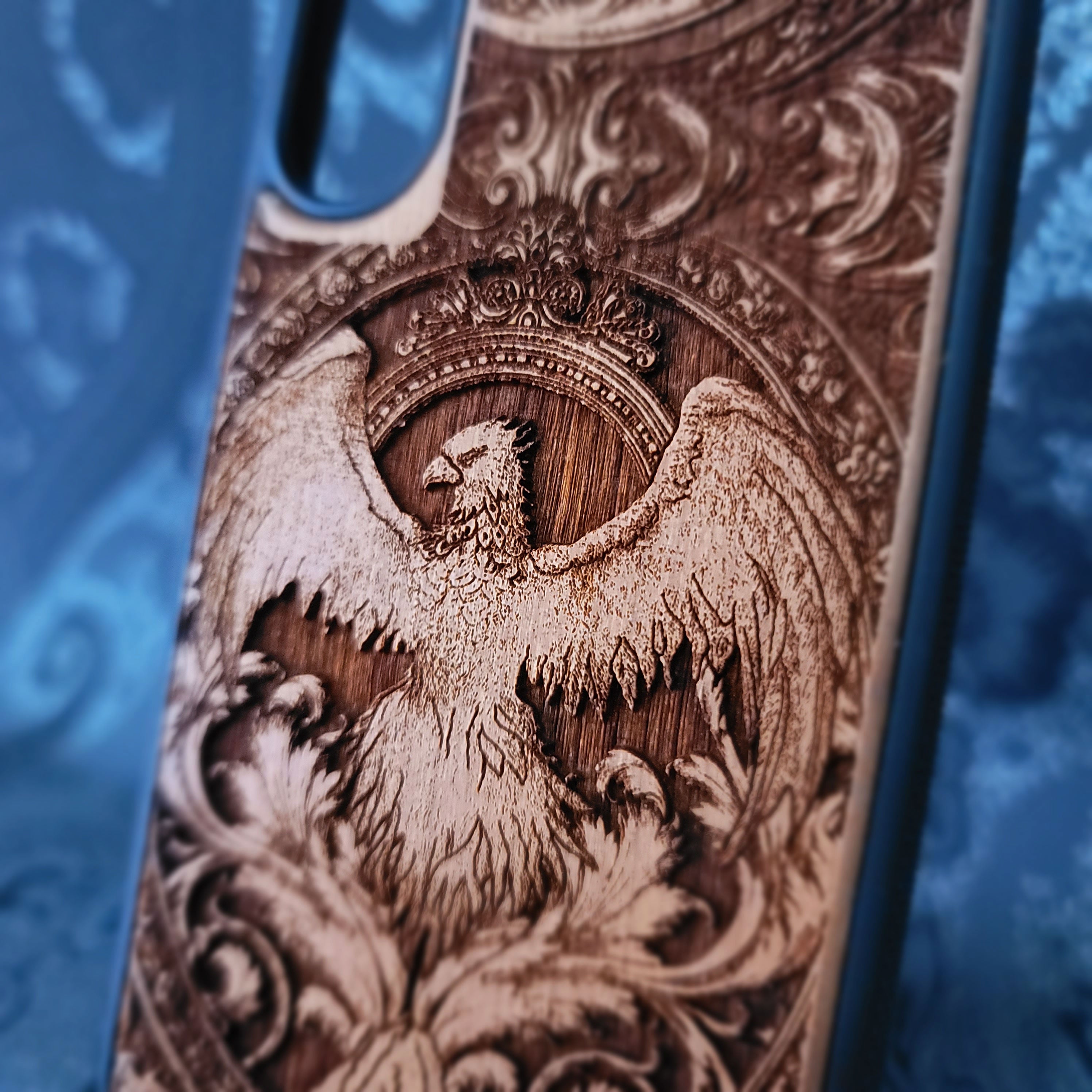 Deep laser engraved wooden phone case featuring a mythical phoenix bird design on natural wood. Available for iPhone and Samsung Galaxy.