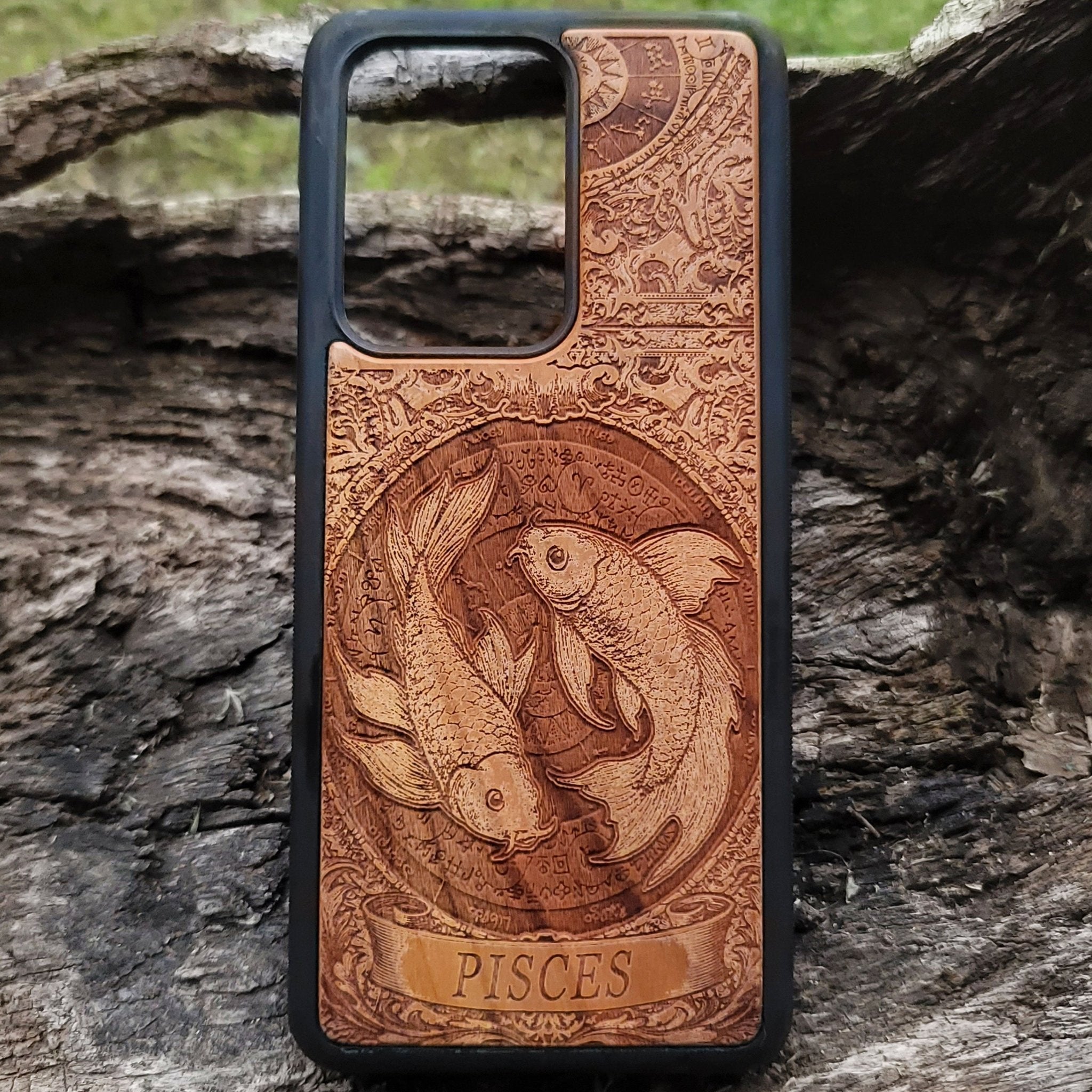 Close-up of engraved Pisces star sign on handcrafted wood case