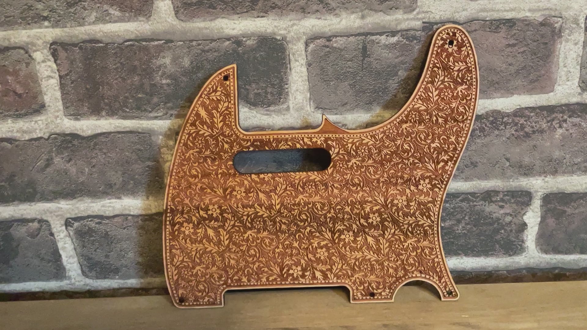 Laser-engraved cherry wood pickguard installed on Fender Telecaster guitar