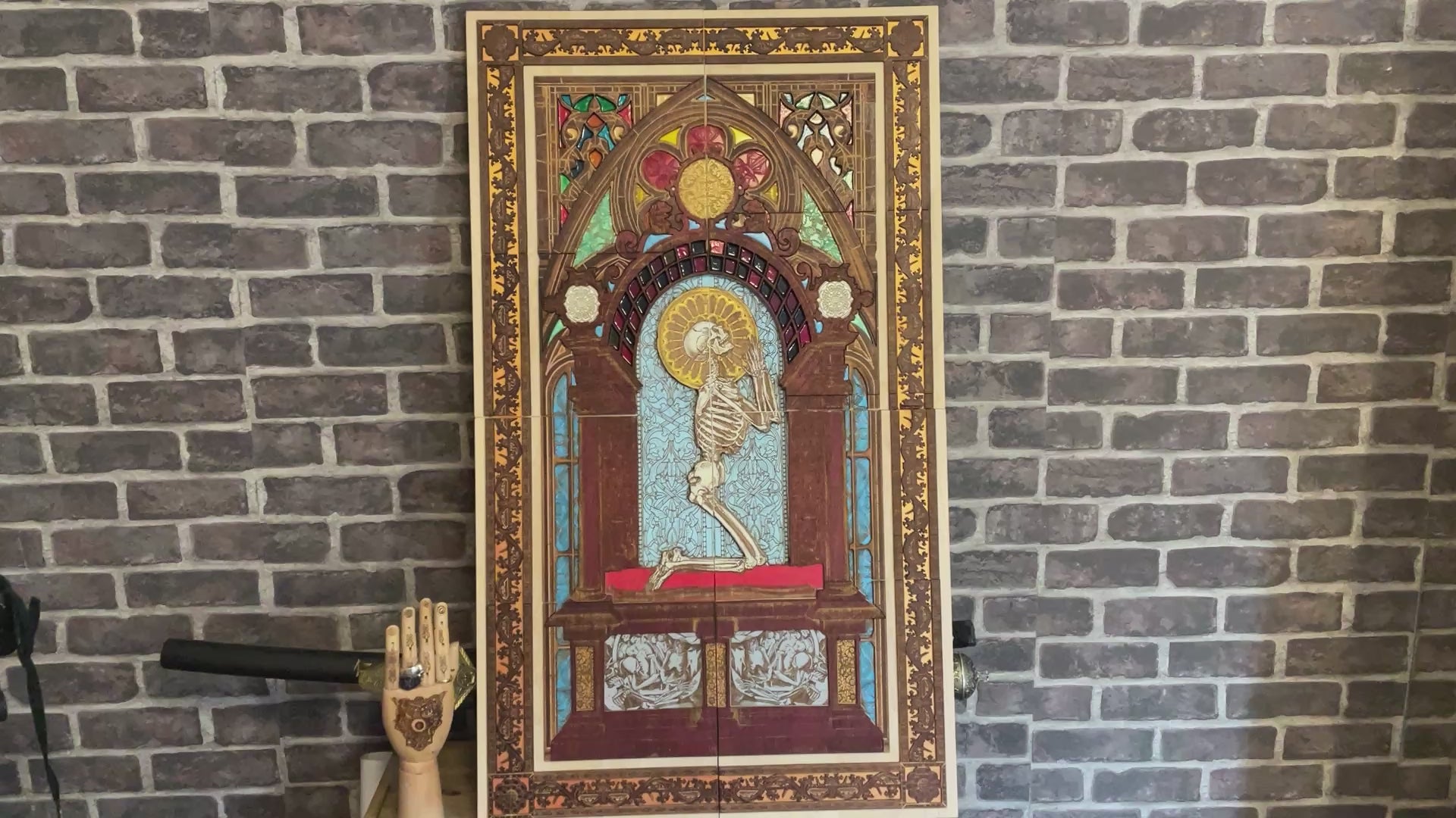 Vintage skeleton figure kneeling in prayer, laser-engraved across wood panel art.