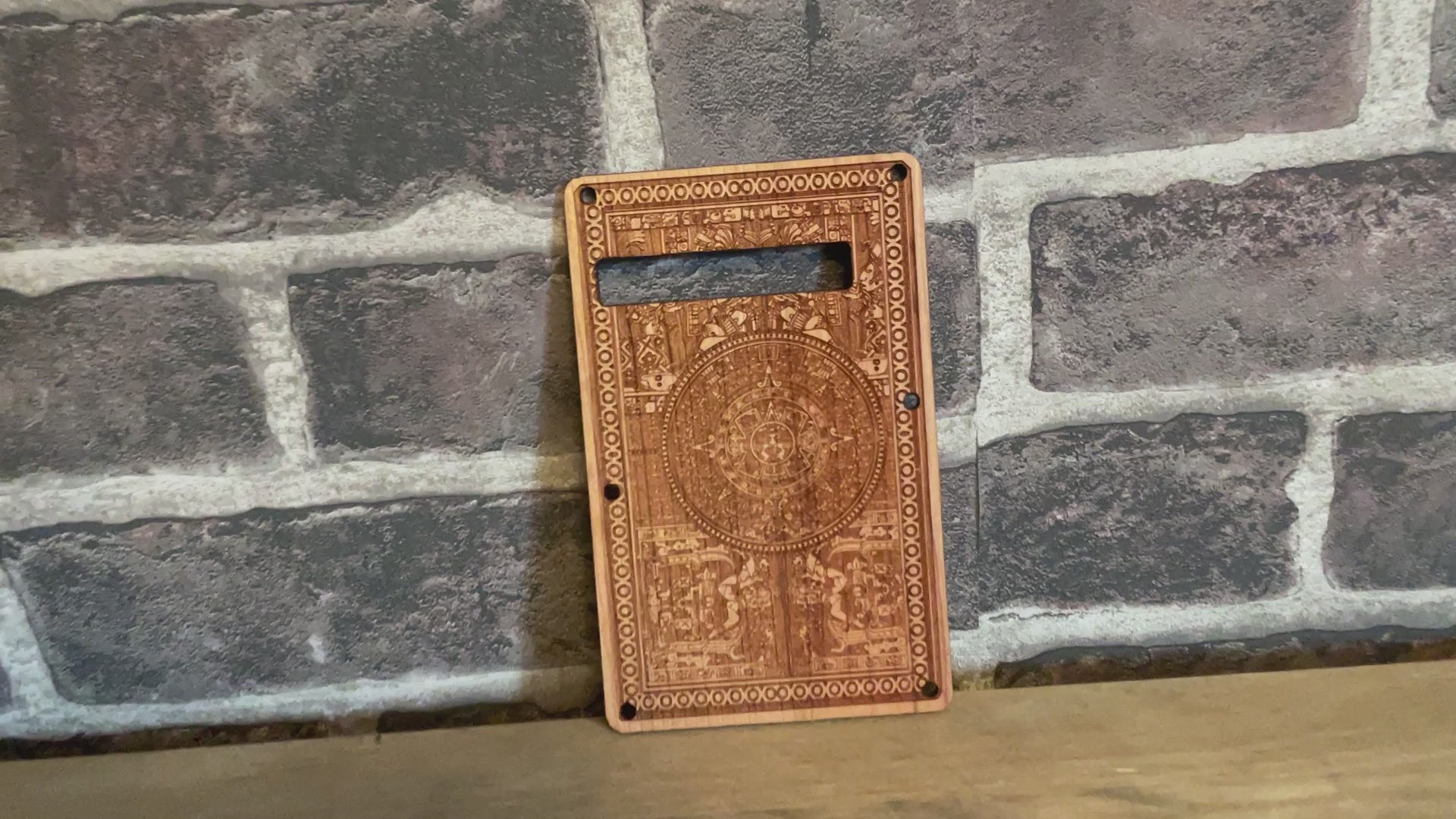 Hand-finished Stratocaster tremolo cover in cherry wood with intricate laser detailing