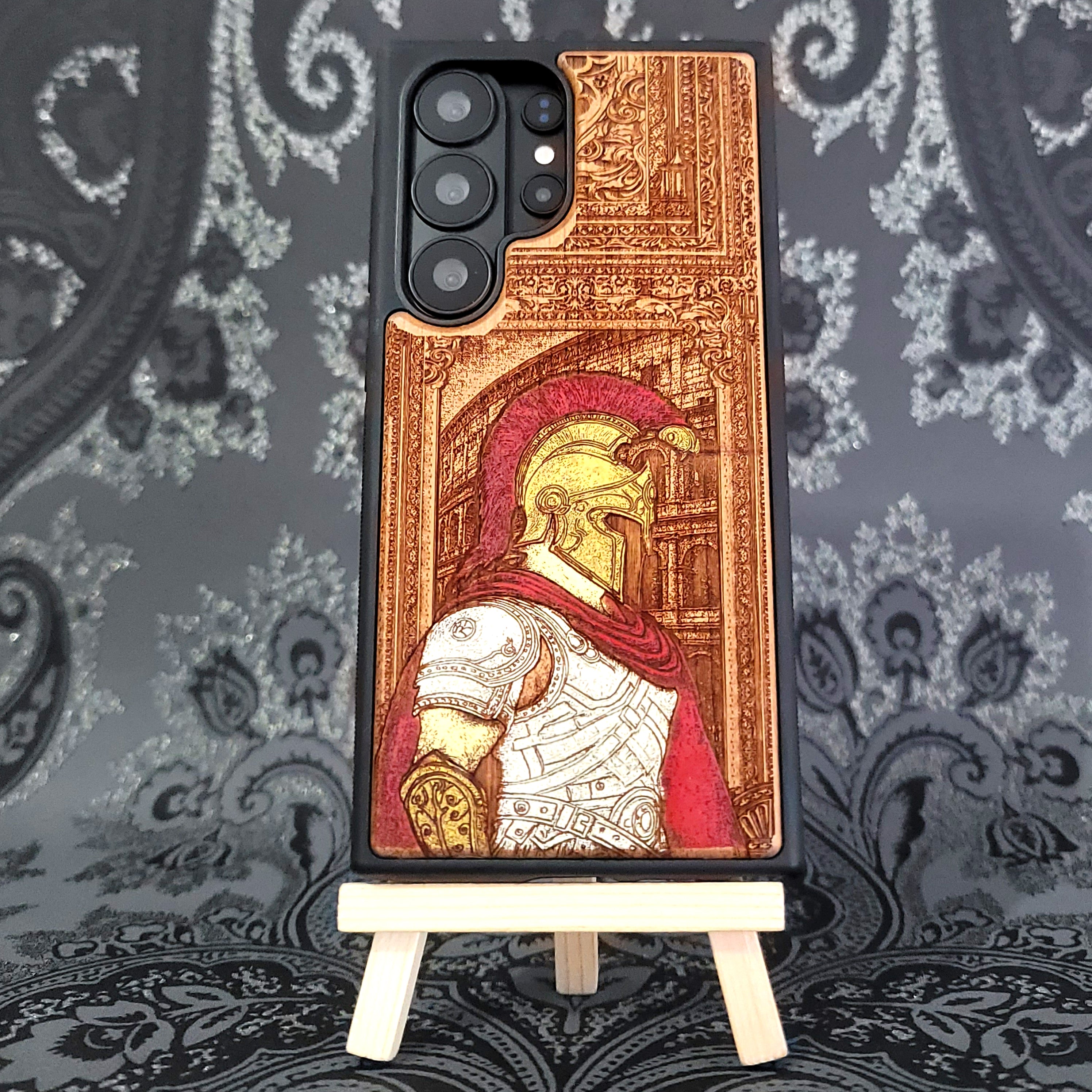 Deep laser engraved wooden phone case featuring a Roman centurion soldier in detailed legionnaire armor on natural wood for iPhone and Samsung Galaxy models.
