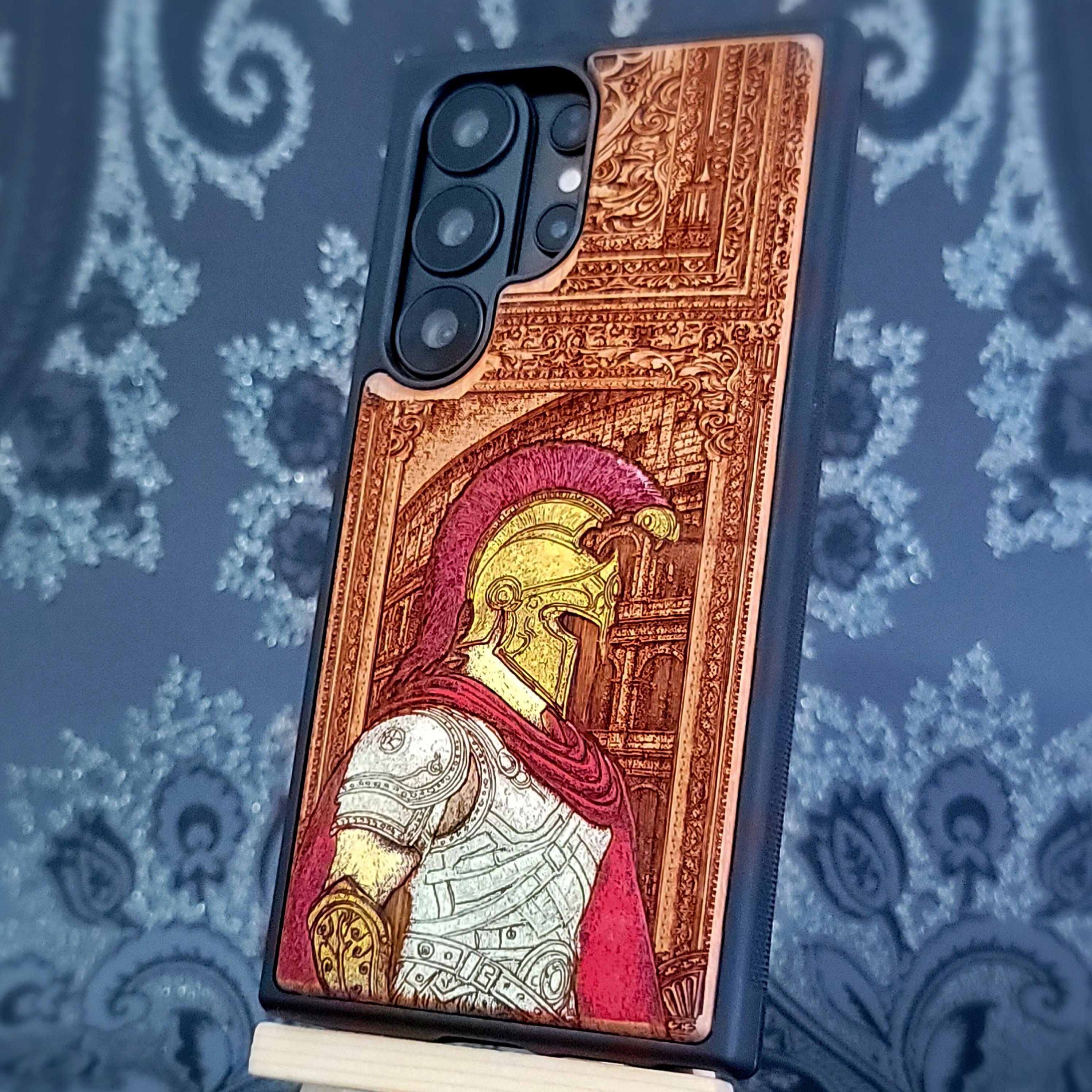 Deep laser engraved wooden phone case featuring a Roman centurion soldier in detailed legionnaire armor on natural wood for iPhone and Samsung Galaxy models.