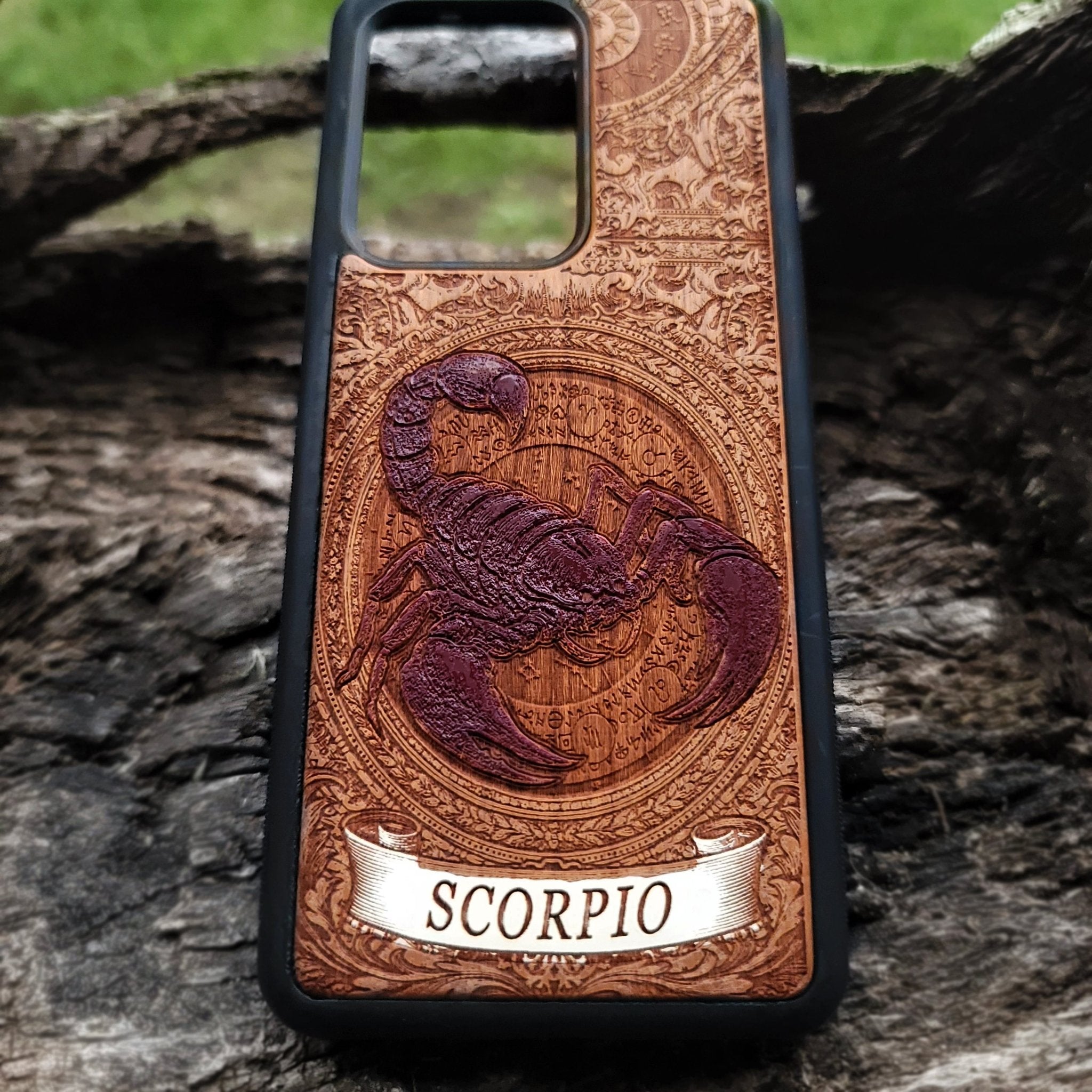 Engraved wood phone case featuring Scorpio zodiac symbol