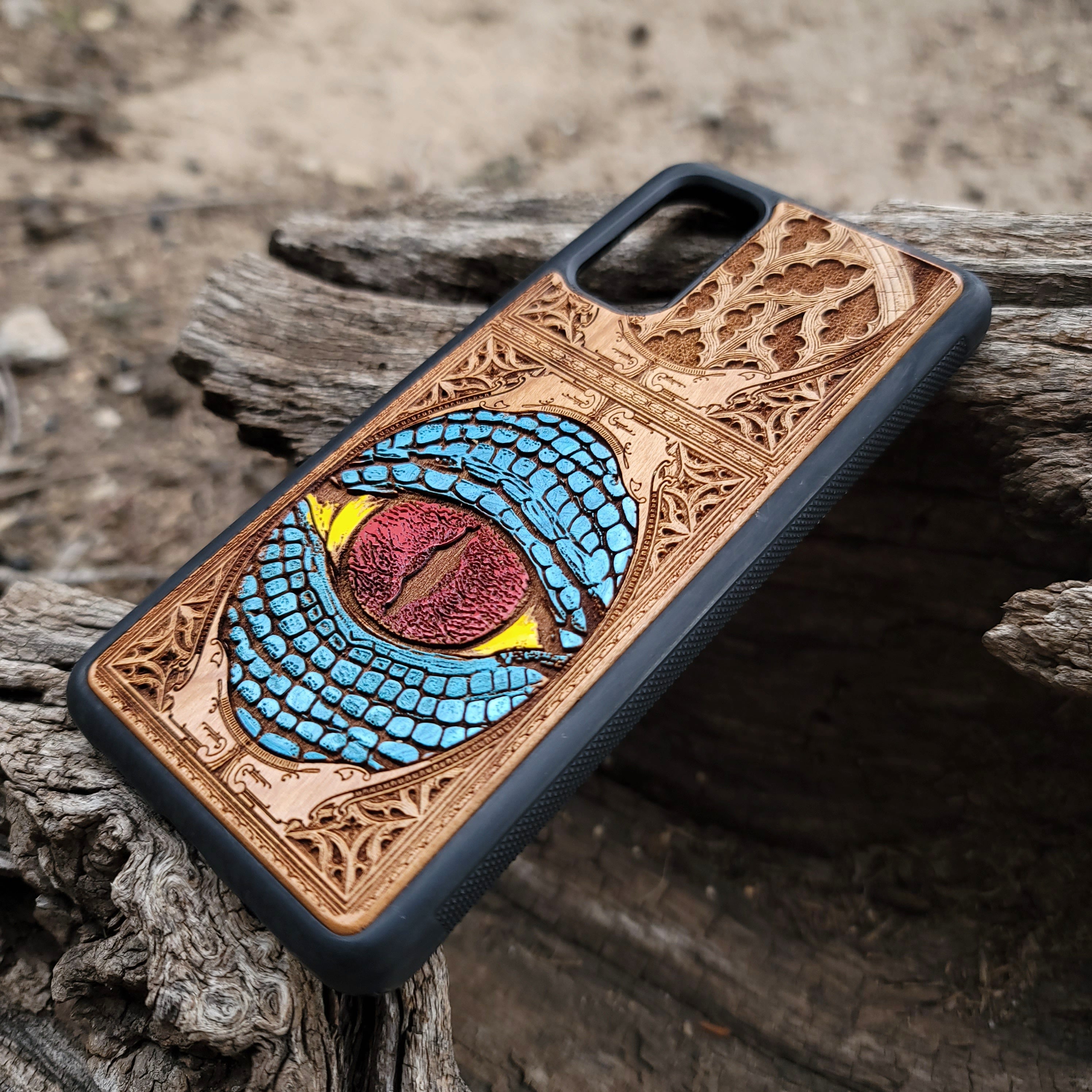 Snake eye gothic artwork engraved on a wooden phone case, compatible with iPhone and Samsung Galaxy S.