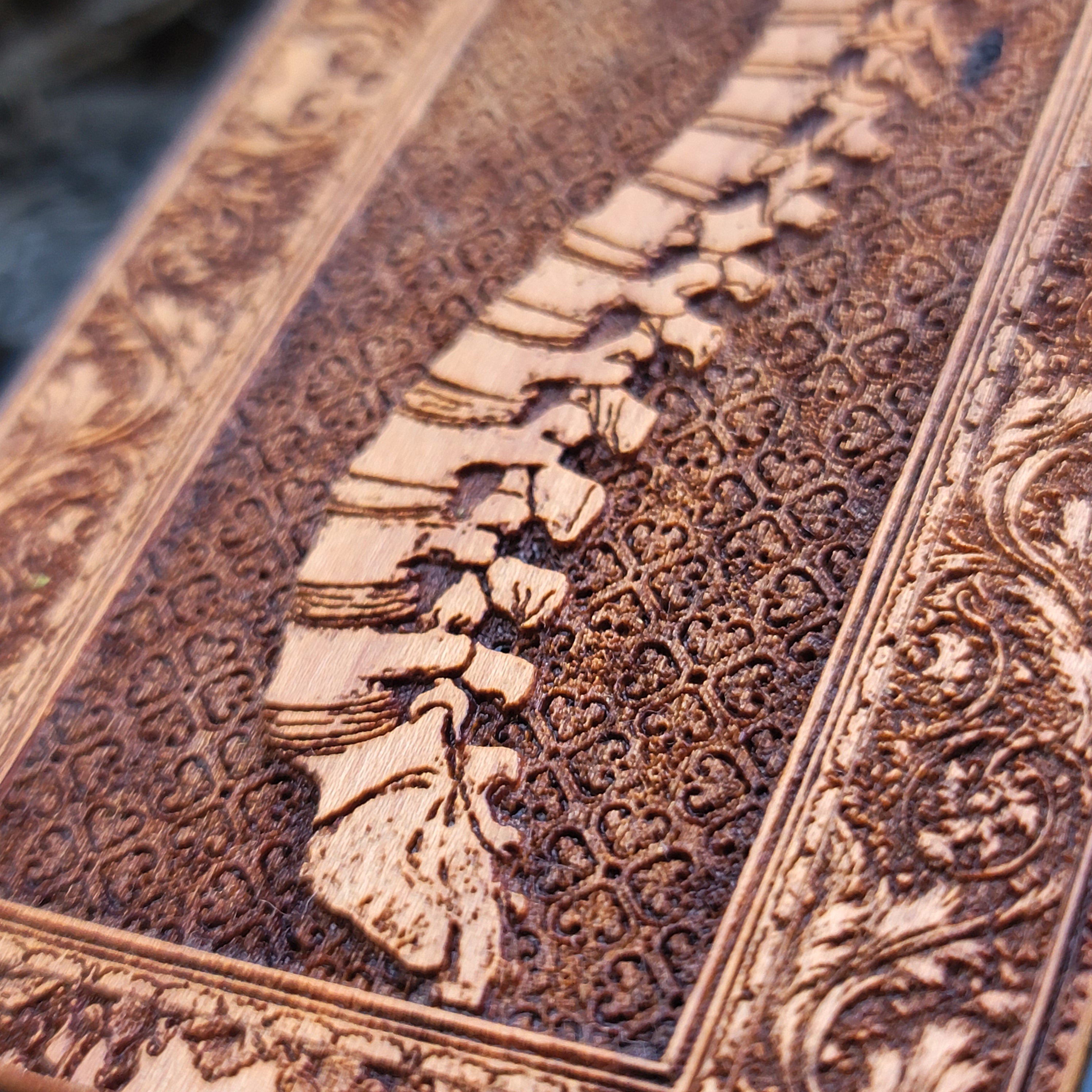 Wooden phone case with detailed skeleton spine carving, designed for iPhone , iPhone 15, Galaxy S, and other models. Perfect for lovers of gothic, anatomical art with premium protection.