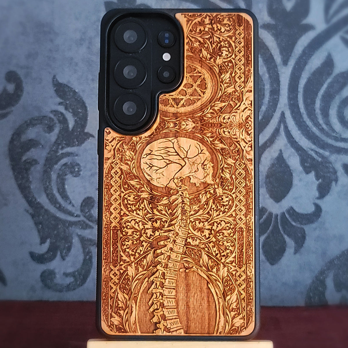 Engraved skull and spine real wood phone case available for selected iPhone Galaxy and Pixel models