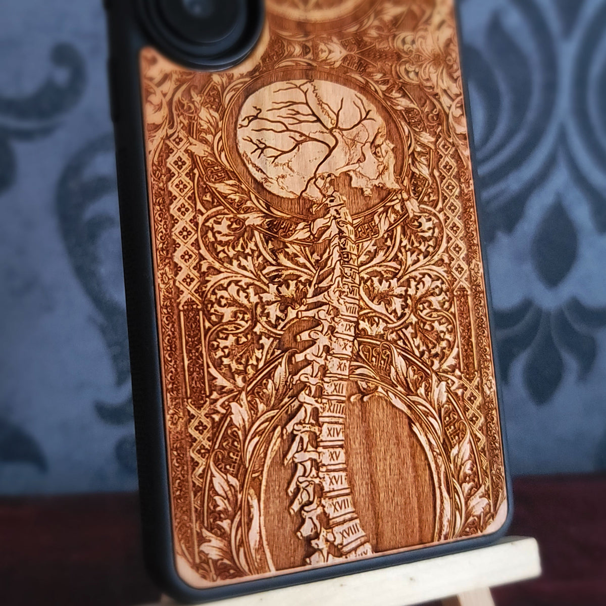 Real wood phone case with slim black protective frame anti-slip sides and raised camera edge