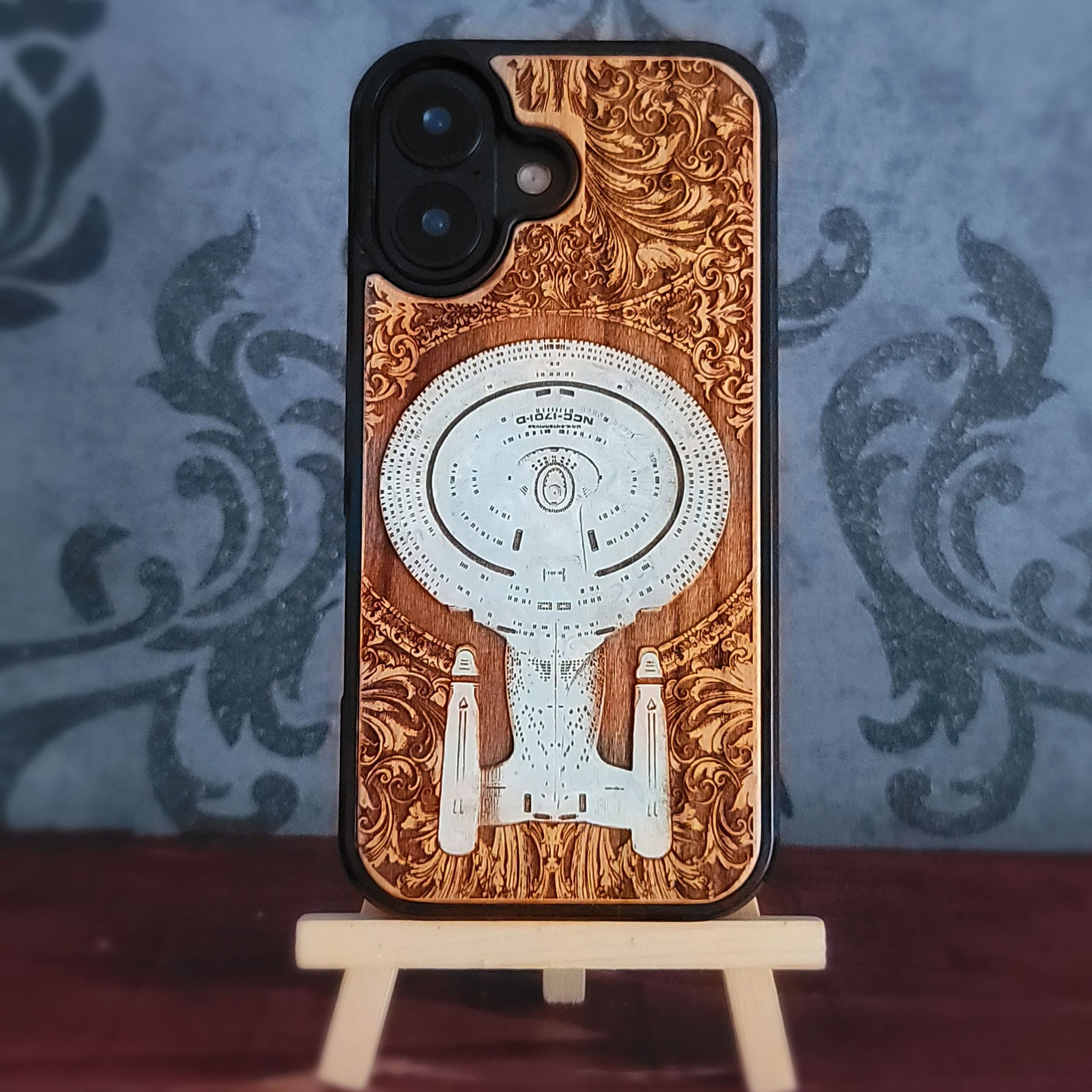 Enterprise NCC-1701-D hand-painted cherrywood phone case, full rear view with the phone case standing upright