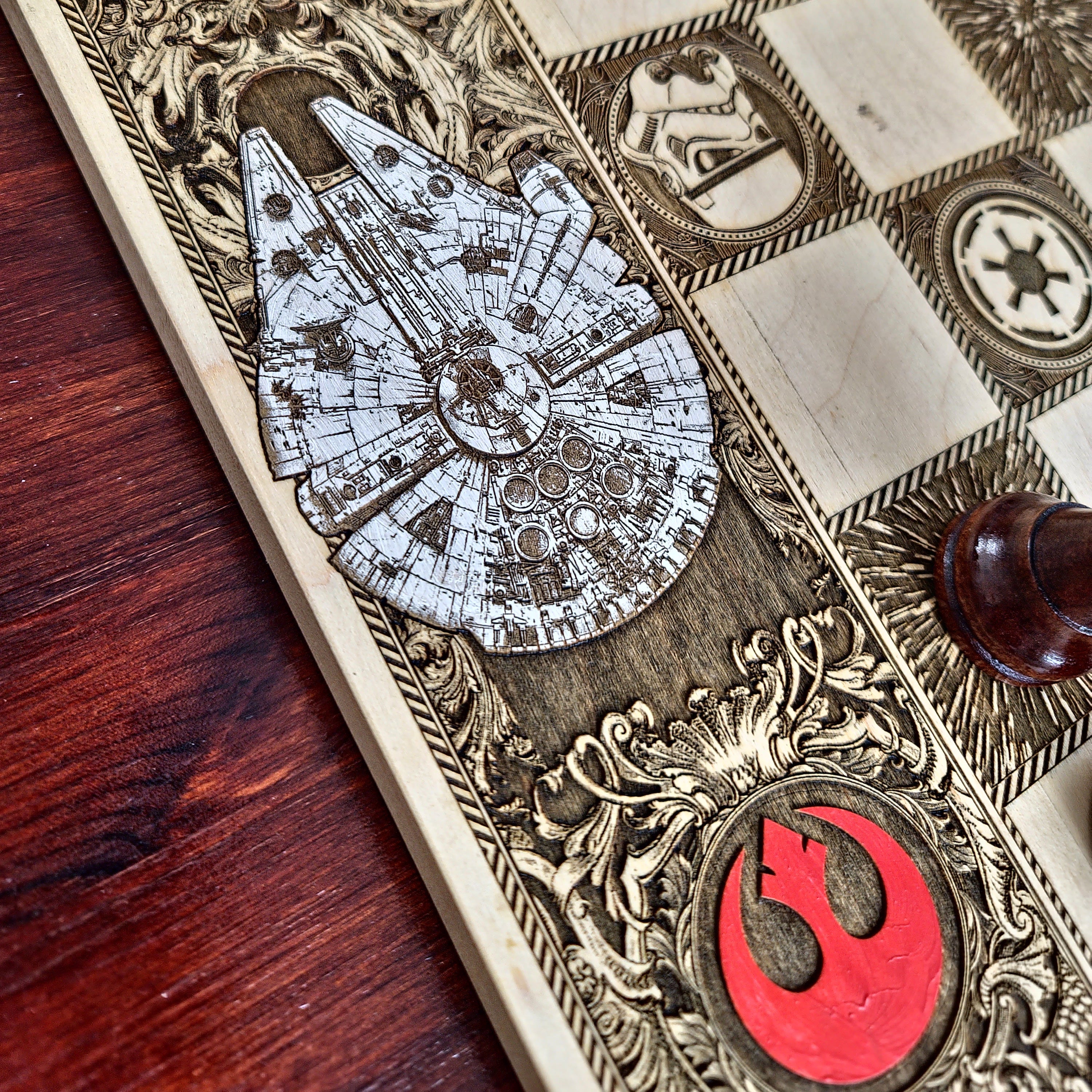 Decorative item with Star Wars design, including Millennium Falcon and Rebel Alliance logo, on a wooden surface.