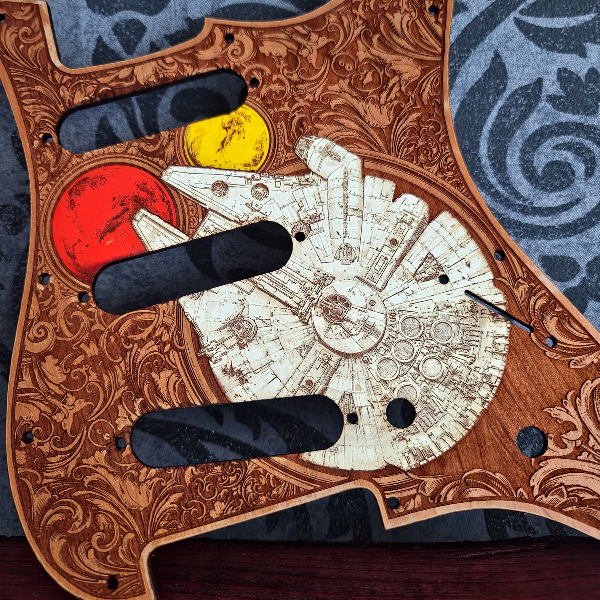 Custom engraved Stratocaster pickguard with painted artwork on natural wood