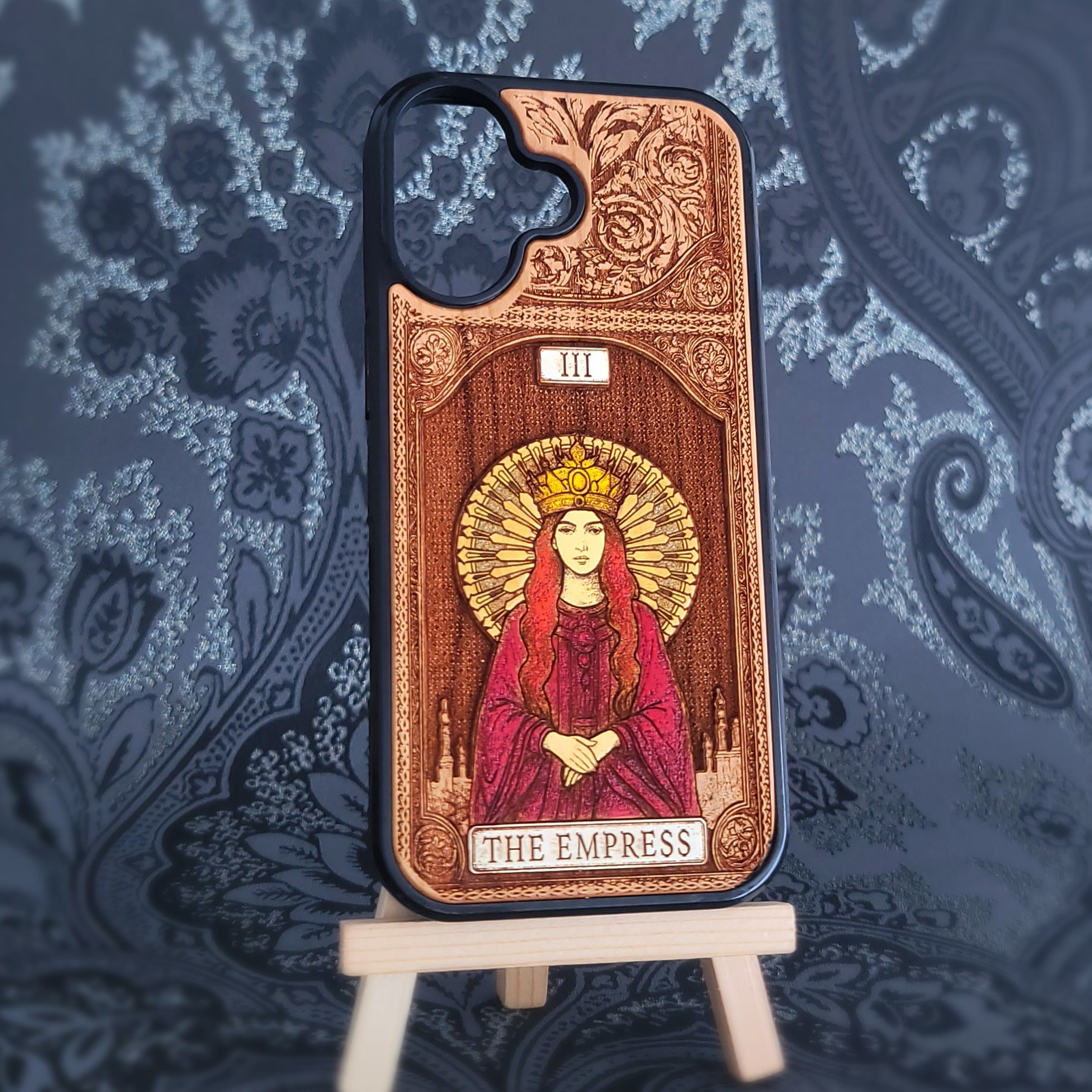 Deep laser engraved wooden phone case featuring The Empress tarot card with mystical celestial details on natural wood for iPhone and Samsung Galaxy models.