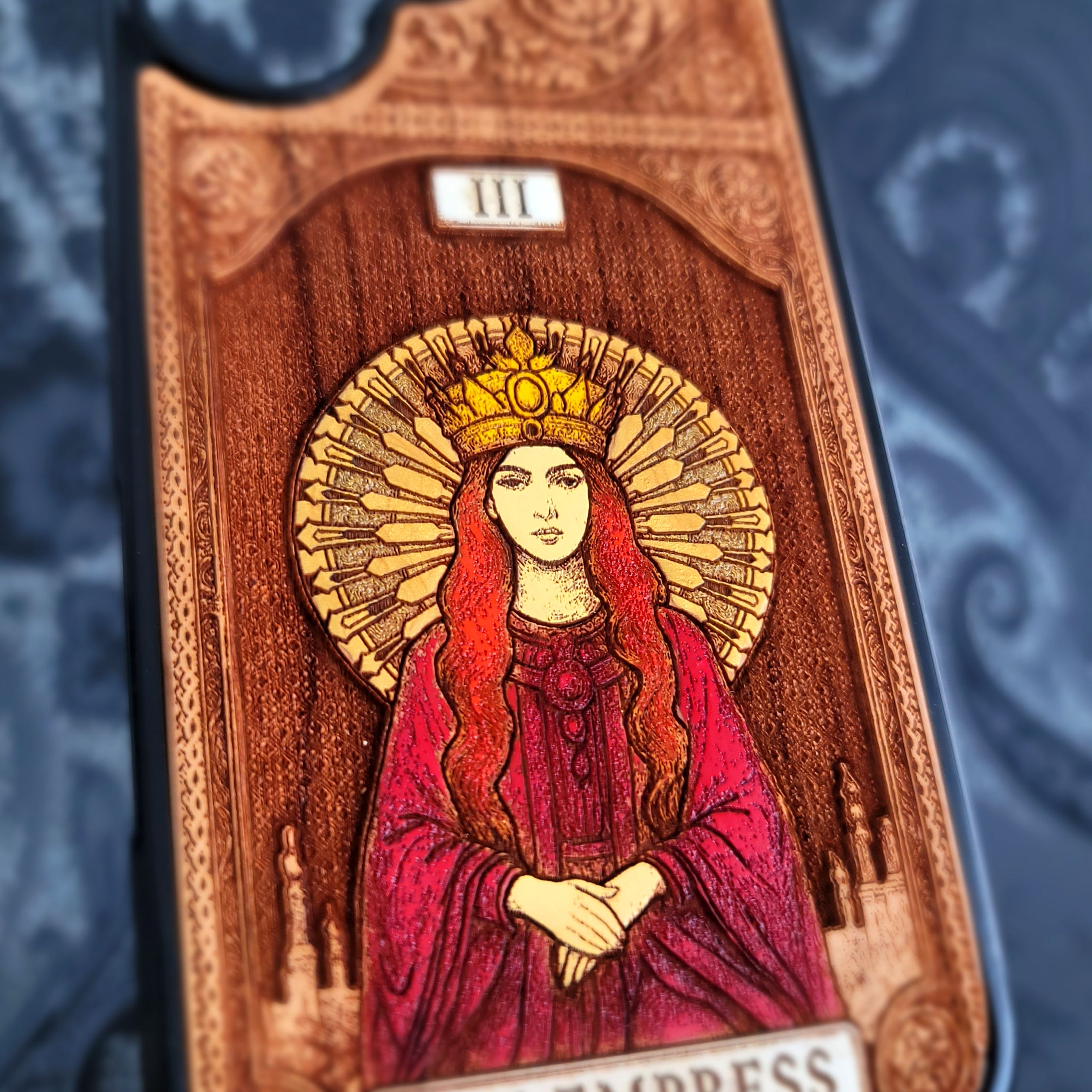 Deep laser engraved wooden phone case featuring The Empress tarot card with mystical celestial details on natural wood for iPhone and Samsung Galaxy models.