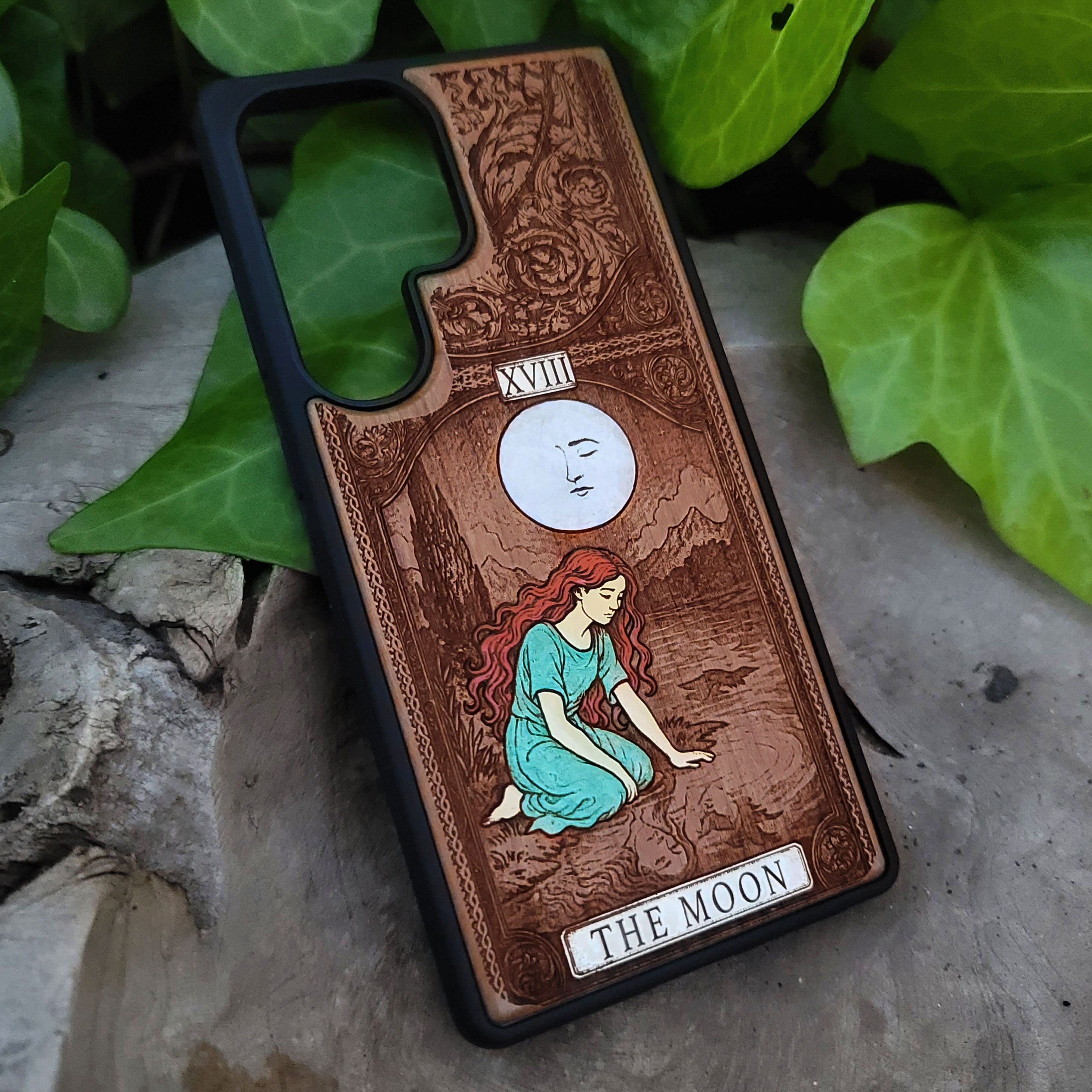 Phone case with 'The Moon' tarot card design on wood