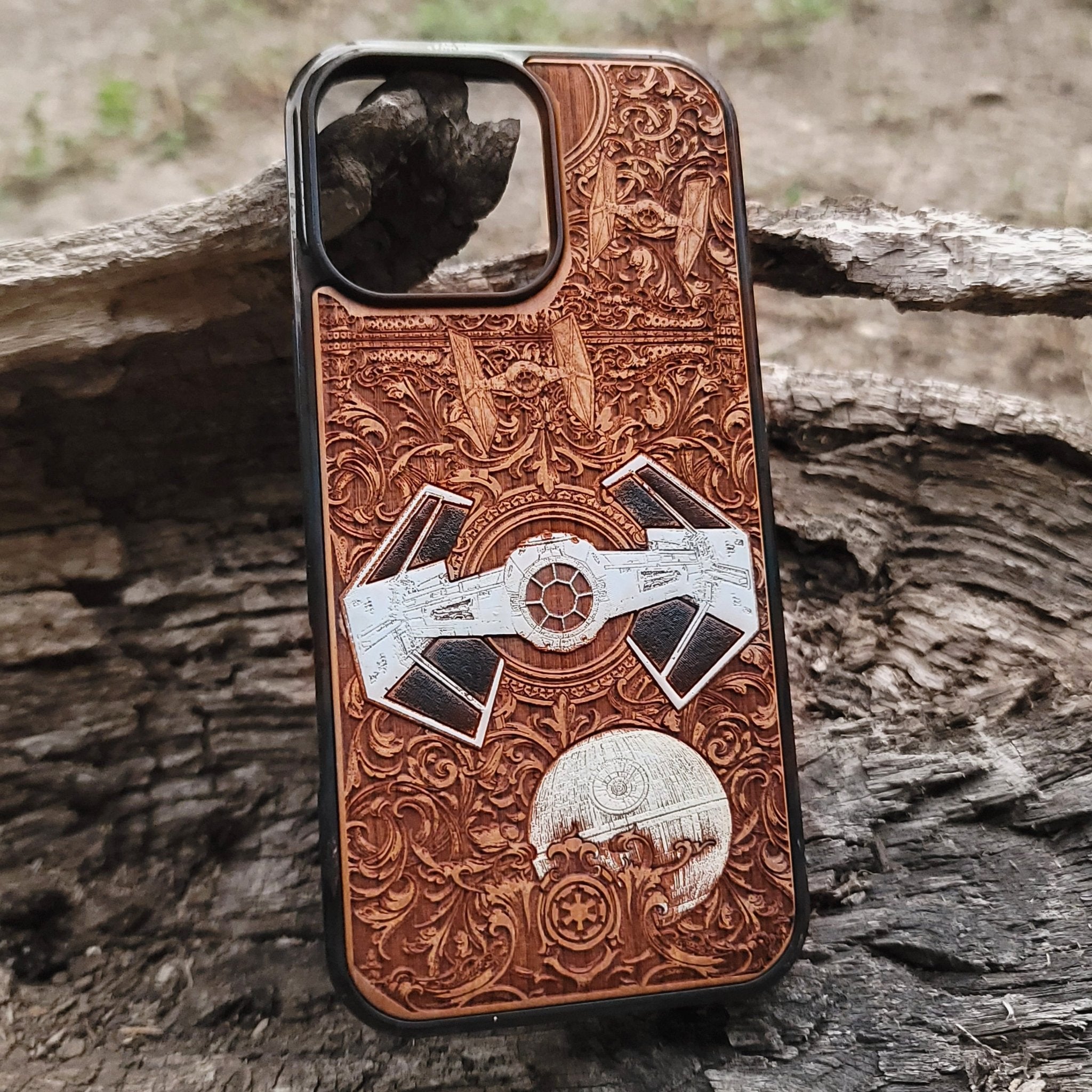 Hand-painted cherry wood phone case with detailed laser engraving of a sci-fi spaceship, perfect for iPhone & Galaxy users.