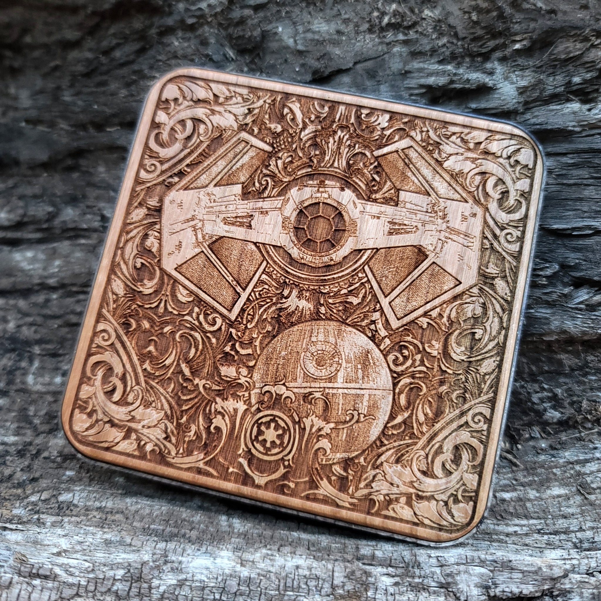 Close-up of engraved galactic battle scene on wireless wood charger.