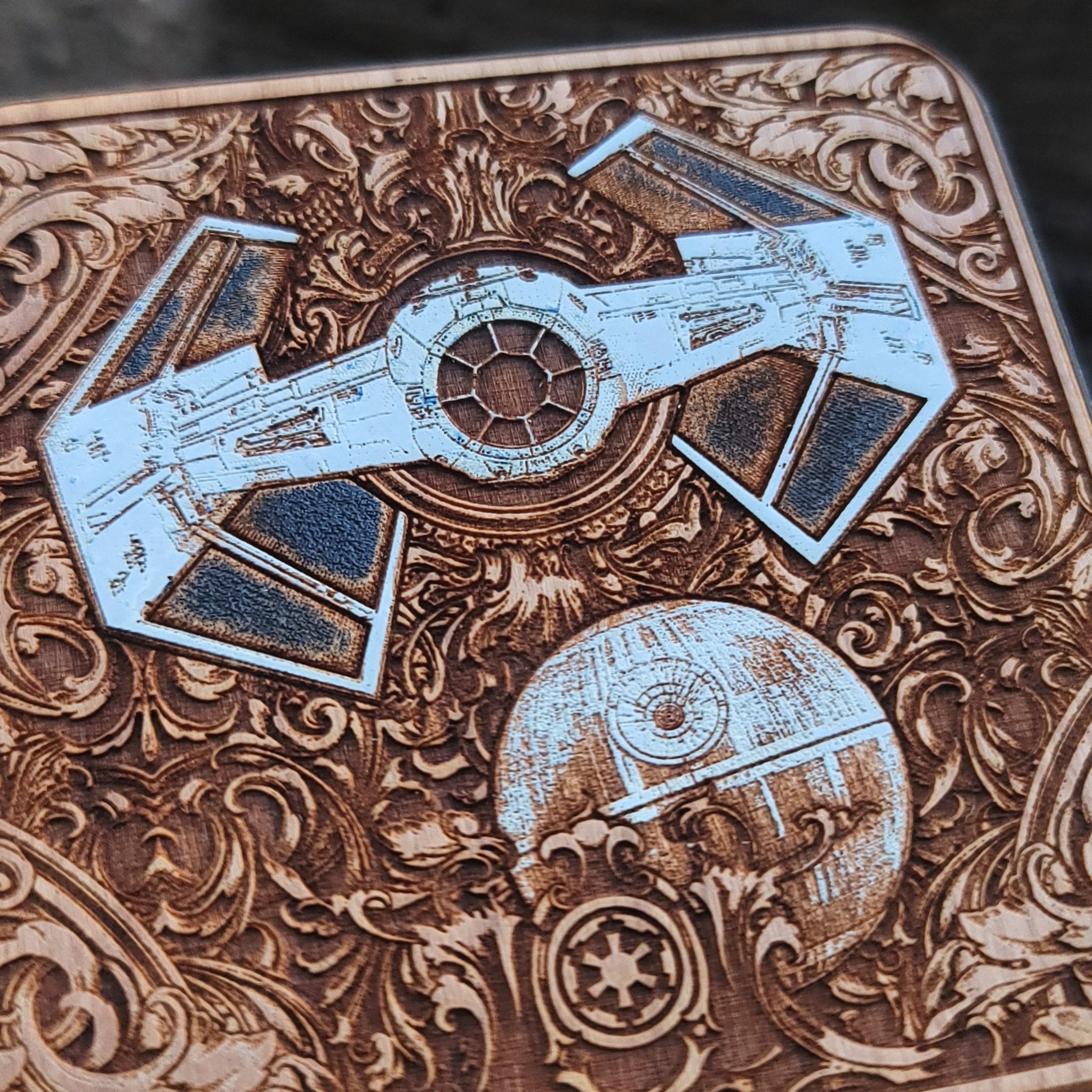 Close-up of starship battle hand-painted on wood wireless charger.