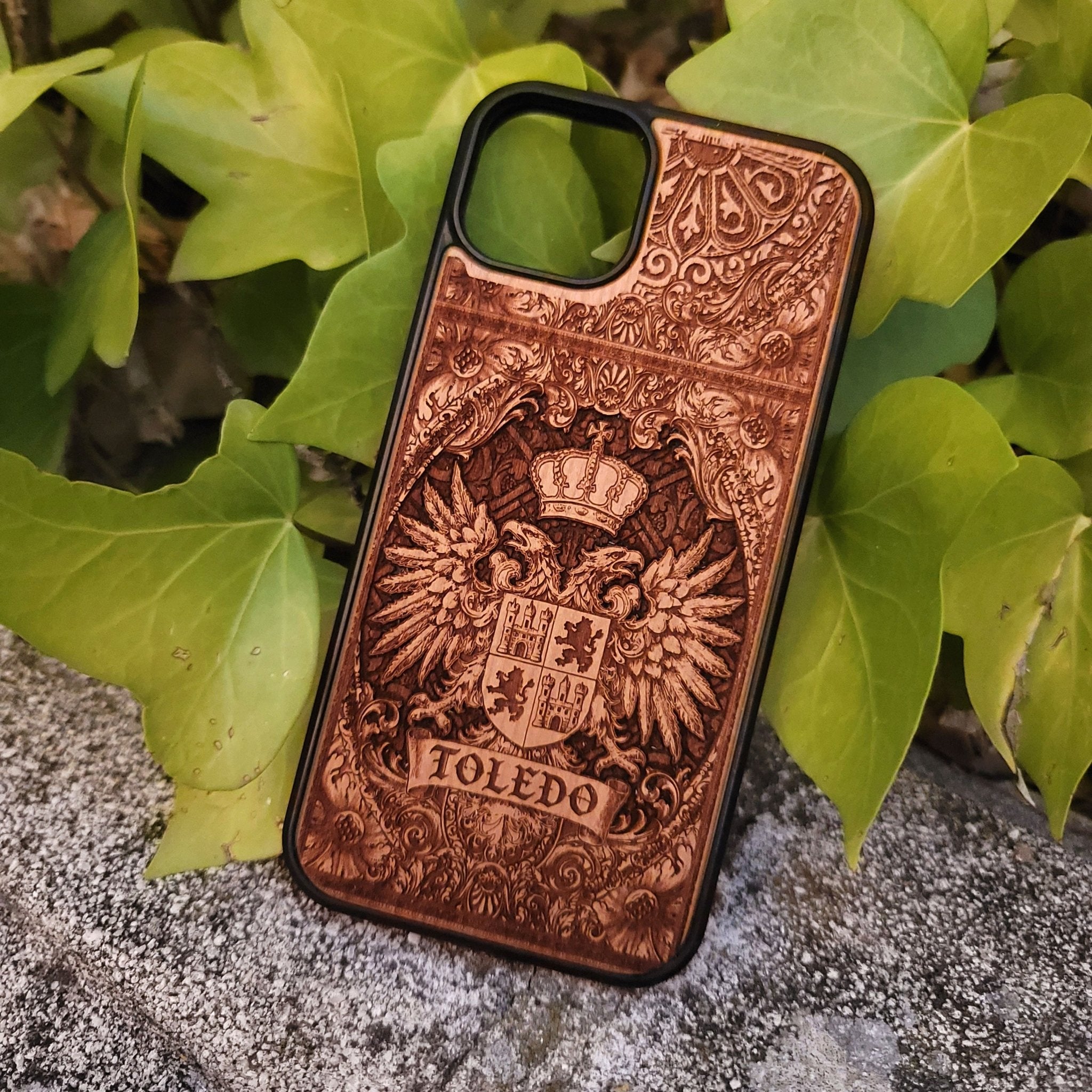 Medieval Toledo crest engraved on a wooden phone case, compatible with iPhone and Samsung Galaxy S.