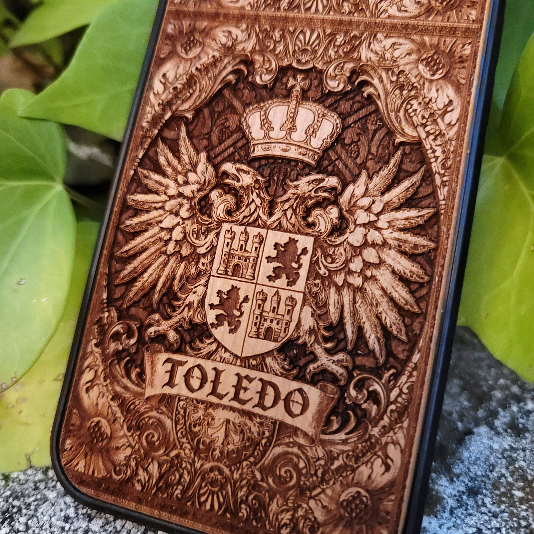 Medieval Toledo crest engraved on a wooden phone case, compatible with iPhone and Samsung Galaxy S.