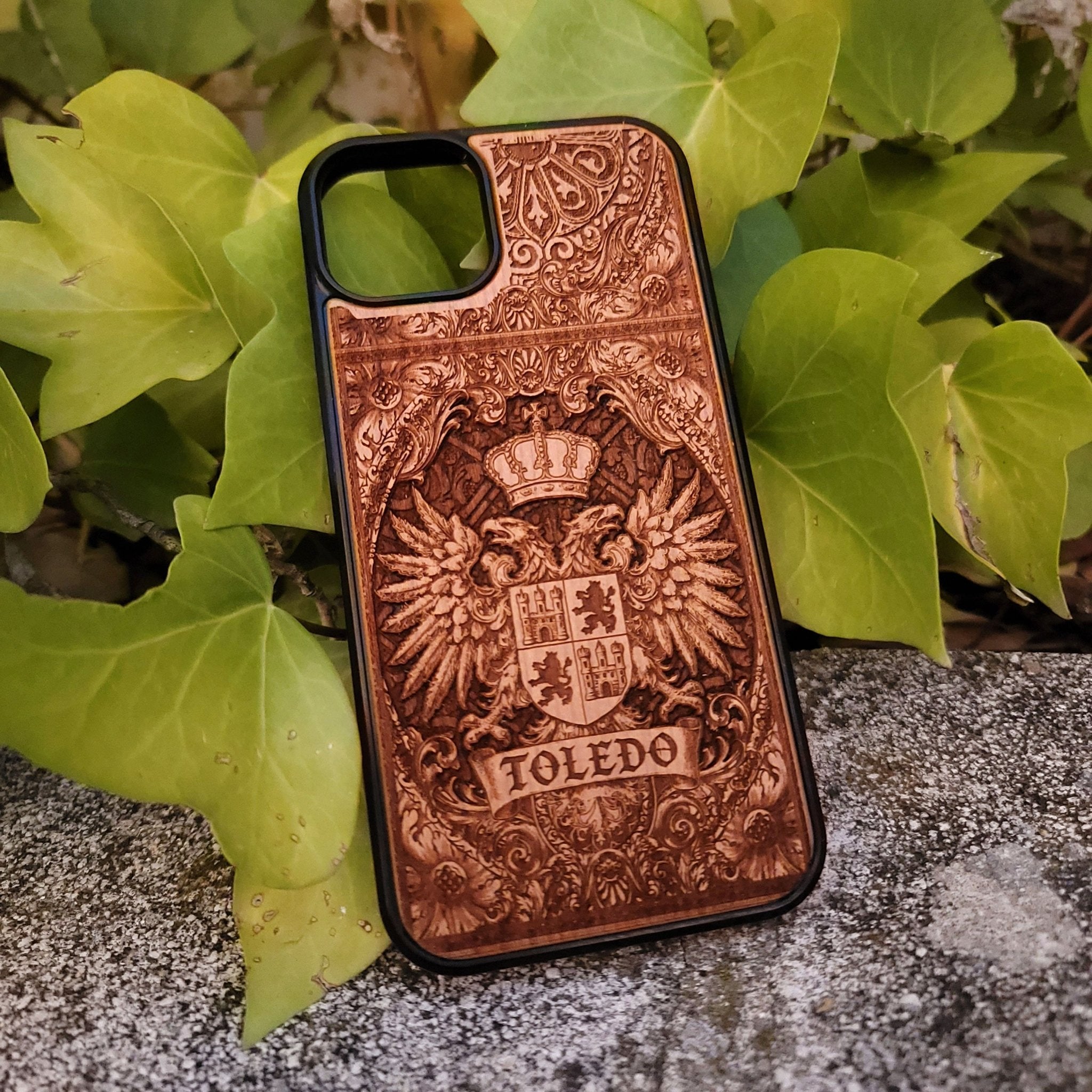 Medieval Toledo crest engraved on a wooden phone case, compatible with iPhone and Samsung Galaxy S.