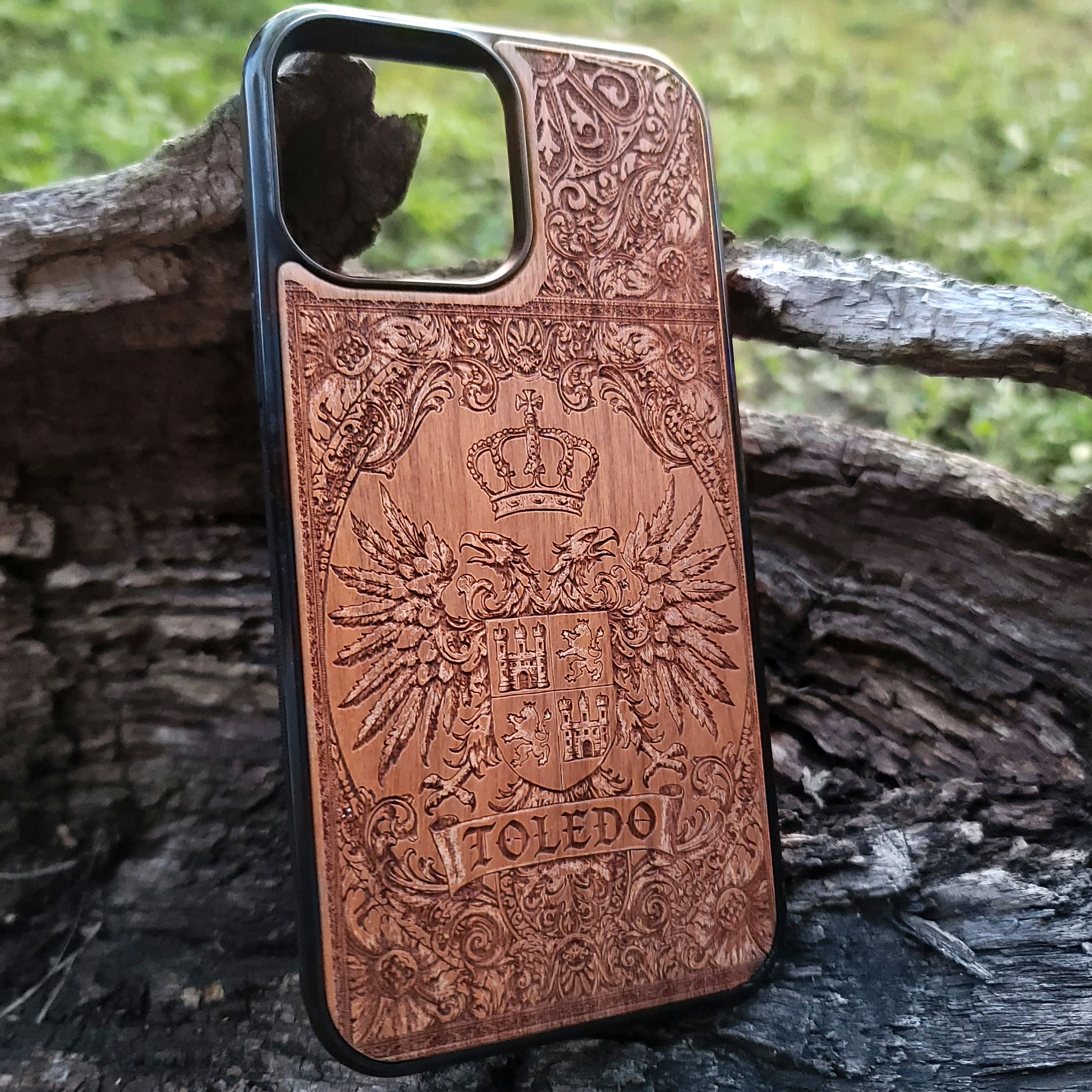 Artisan wood phone case with detailed Toledo coat of arms engraving.