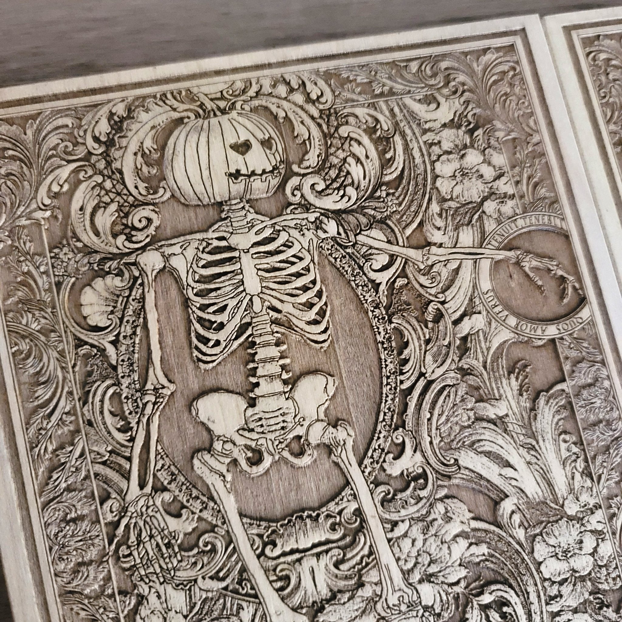 Wooden gothic plaque with engraved skeletons and romantic banner.