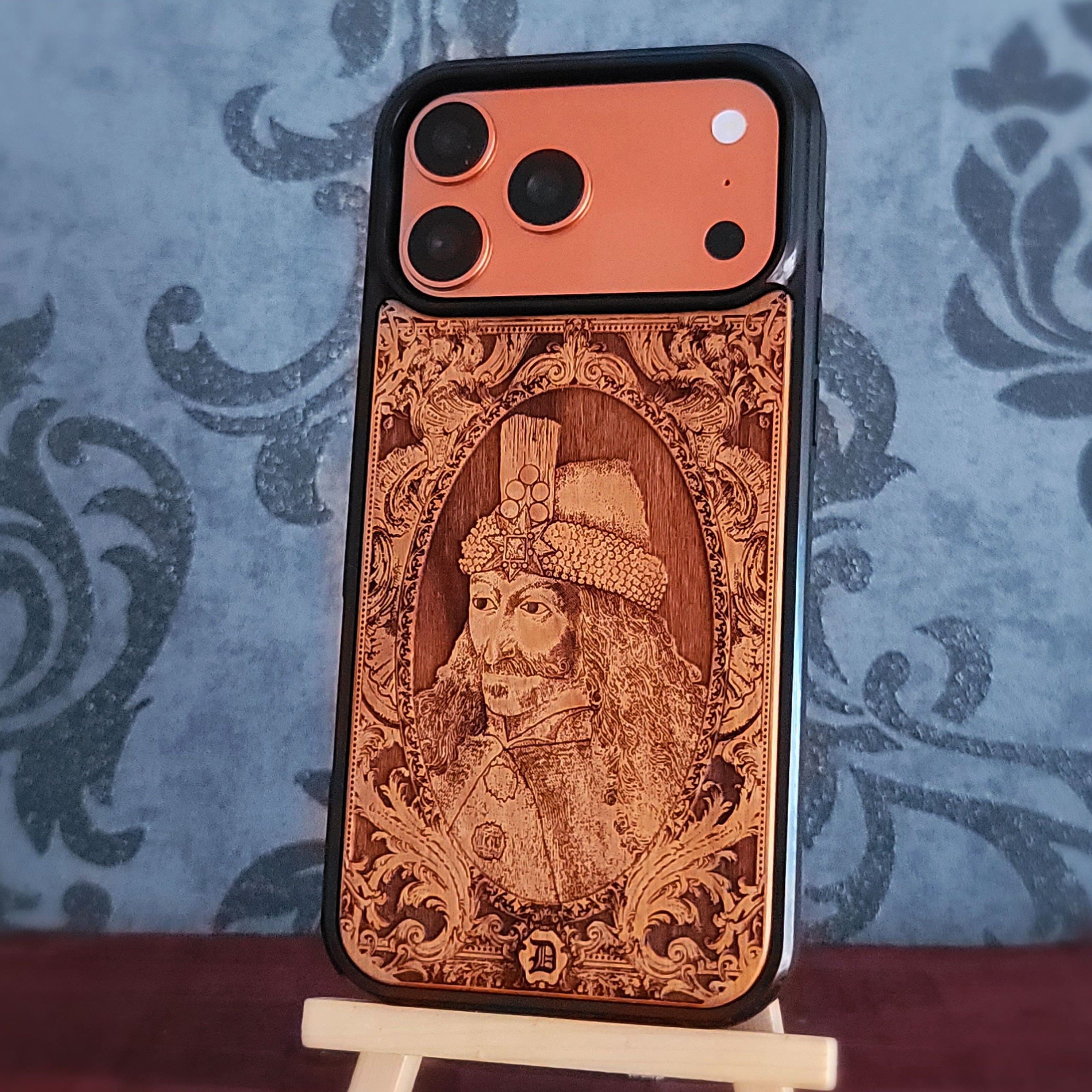 A wooden phone case with a detailed portrait engraving of a historical figure, vlad the impaler dracula