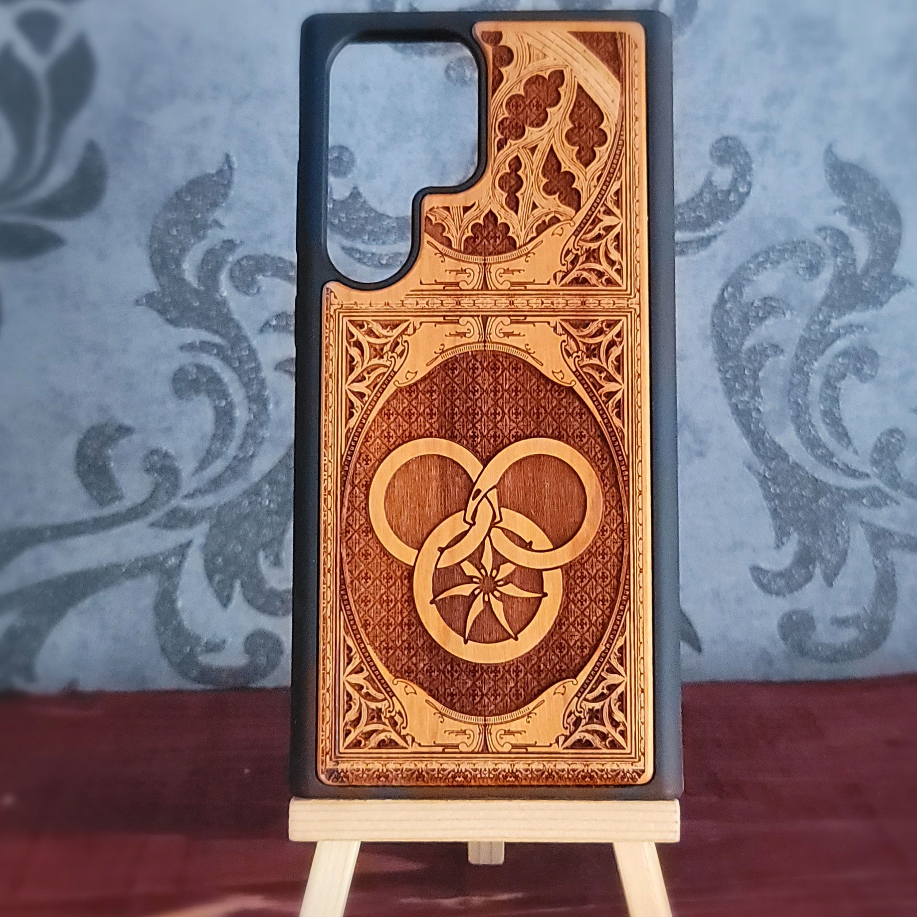 Wheel of Time-inspired wood phone case featuring a Gothic pattern design, laser-engraved for a unique and durable look. Compatible with iPhone and Samsung Galaxy