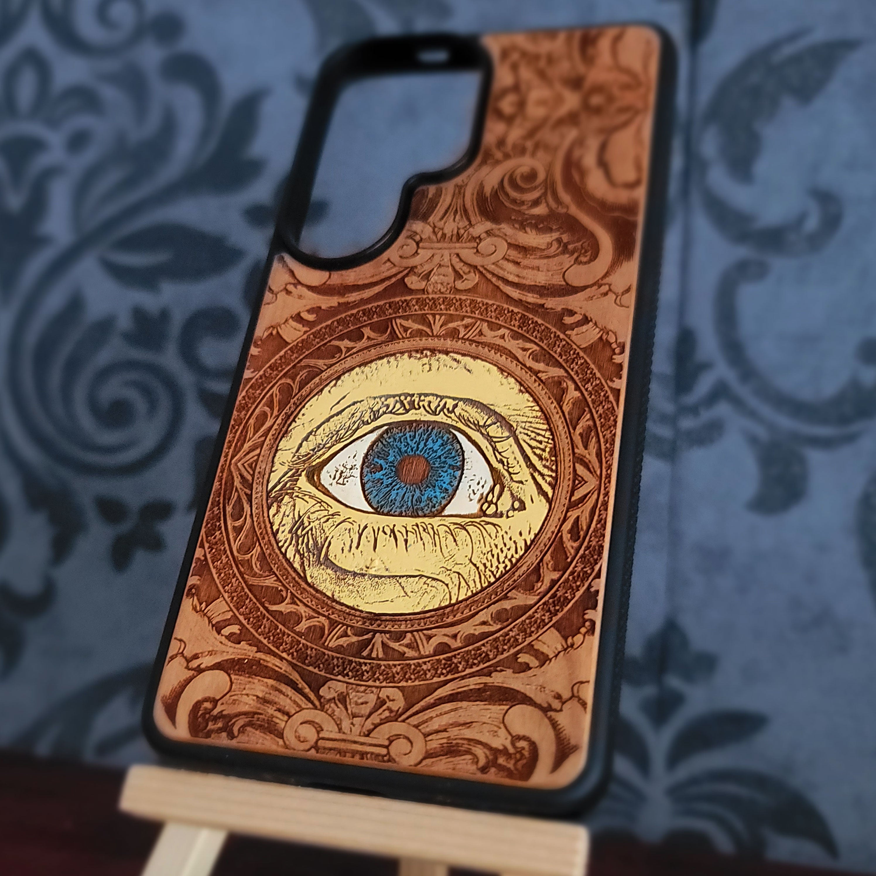 hand painted wood phone case featuring a human eye laser engraved