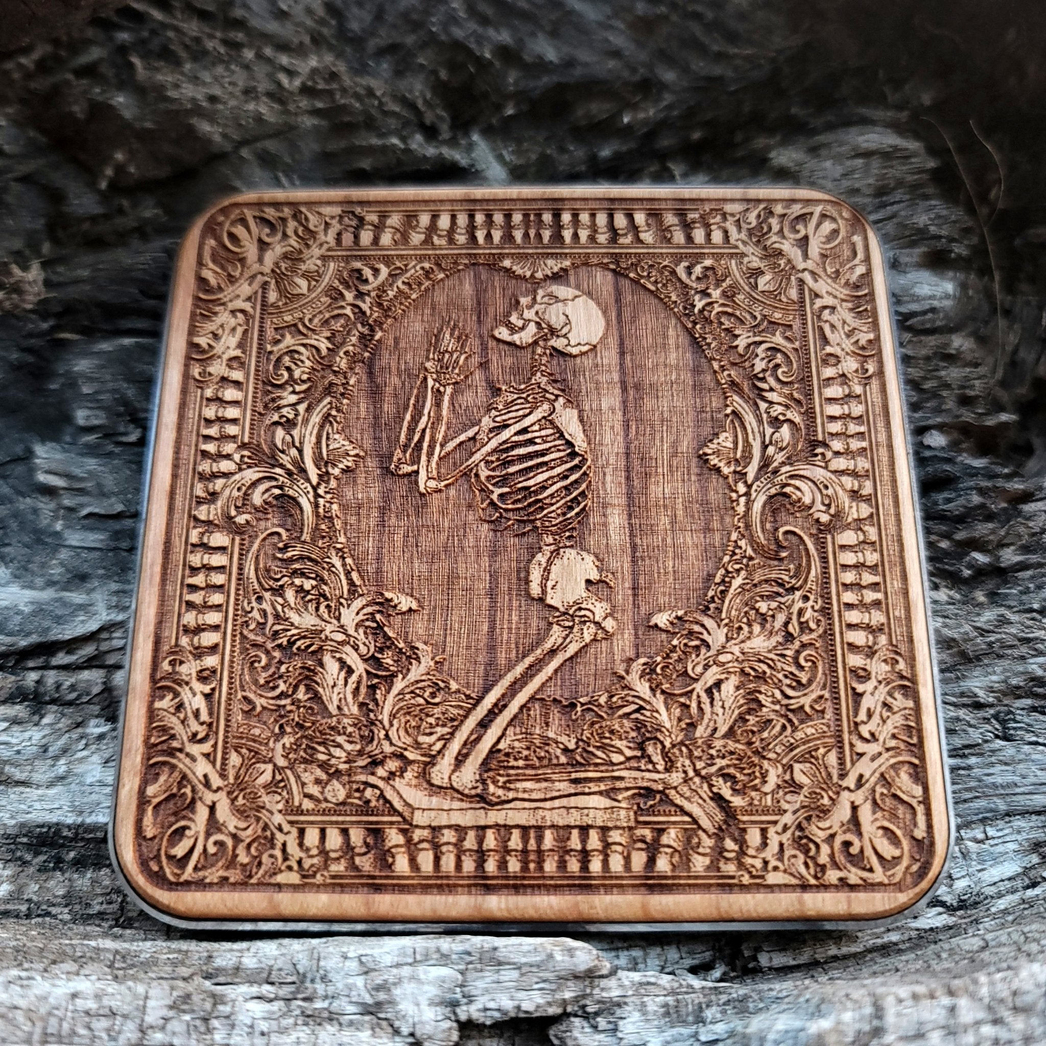 Close-up of hand-painted Pray figure on artisan wood charger.