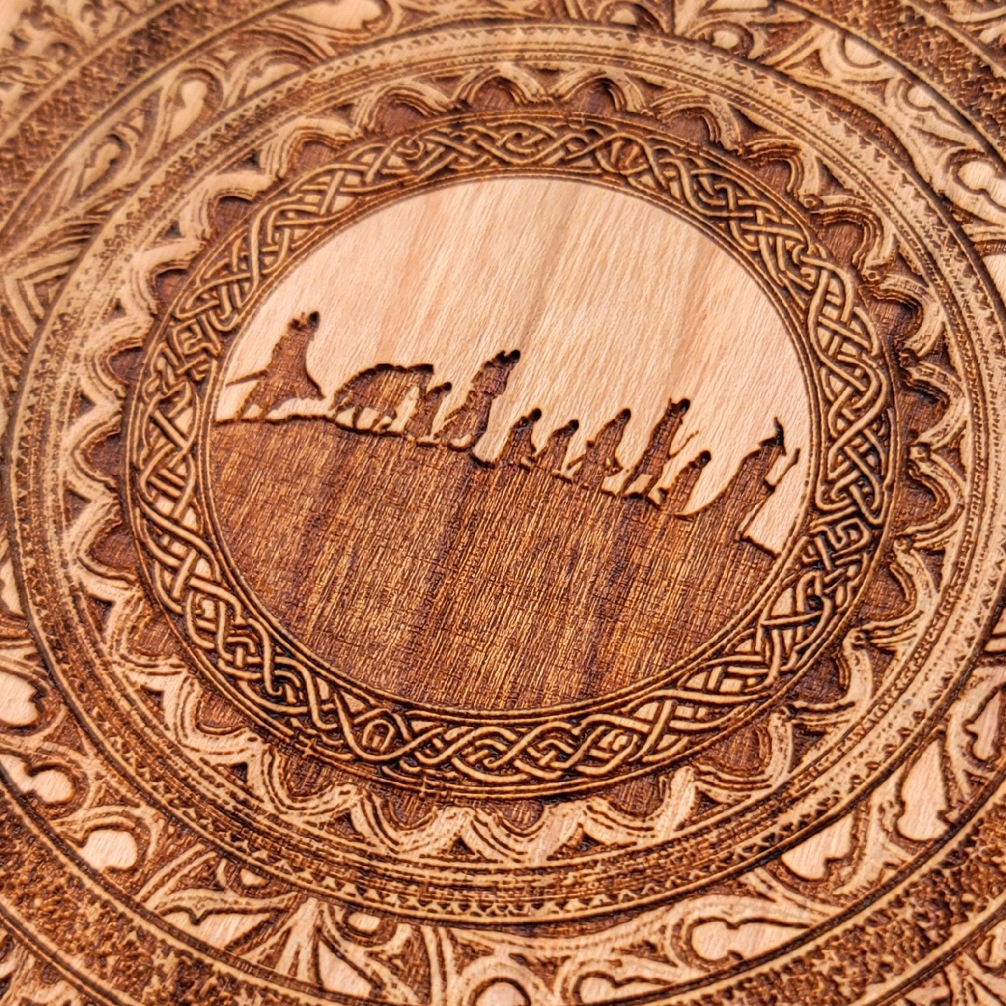 Close-up of the Fellowship silhouette painted on wood charger.