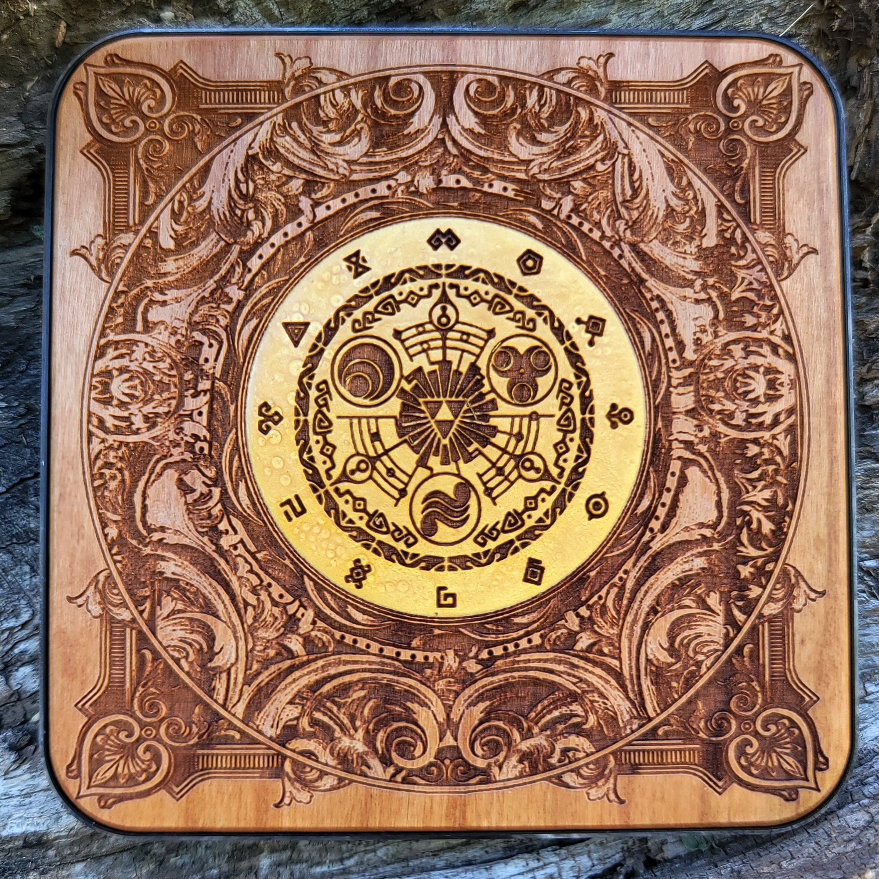 Hand-painted wooden wireless charger with Zelda Triforce design.