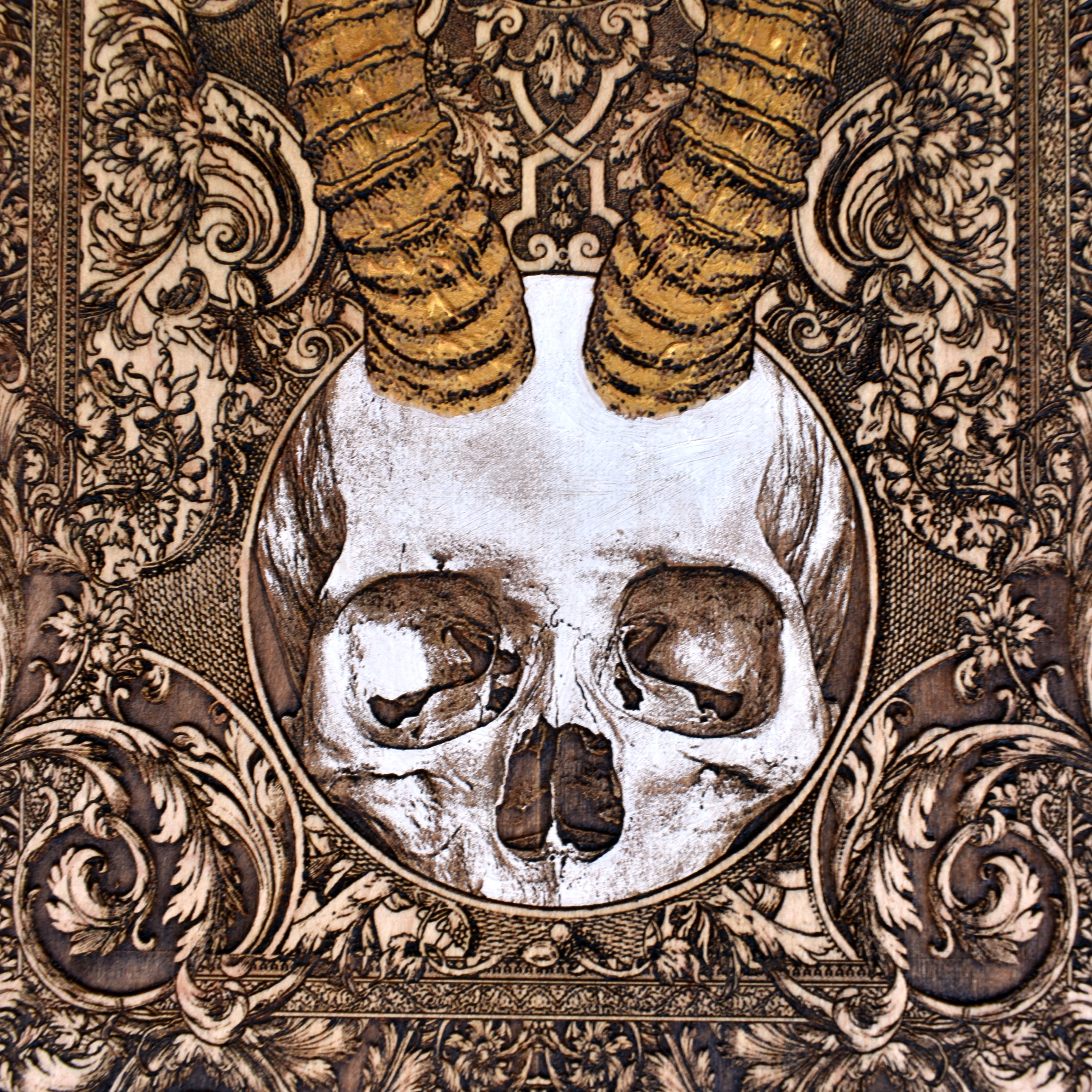 Unique dark art horned skull plaque, engraved on stained wood.