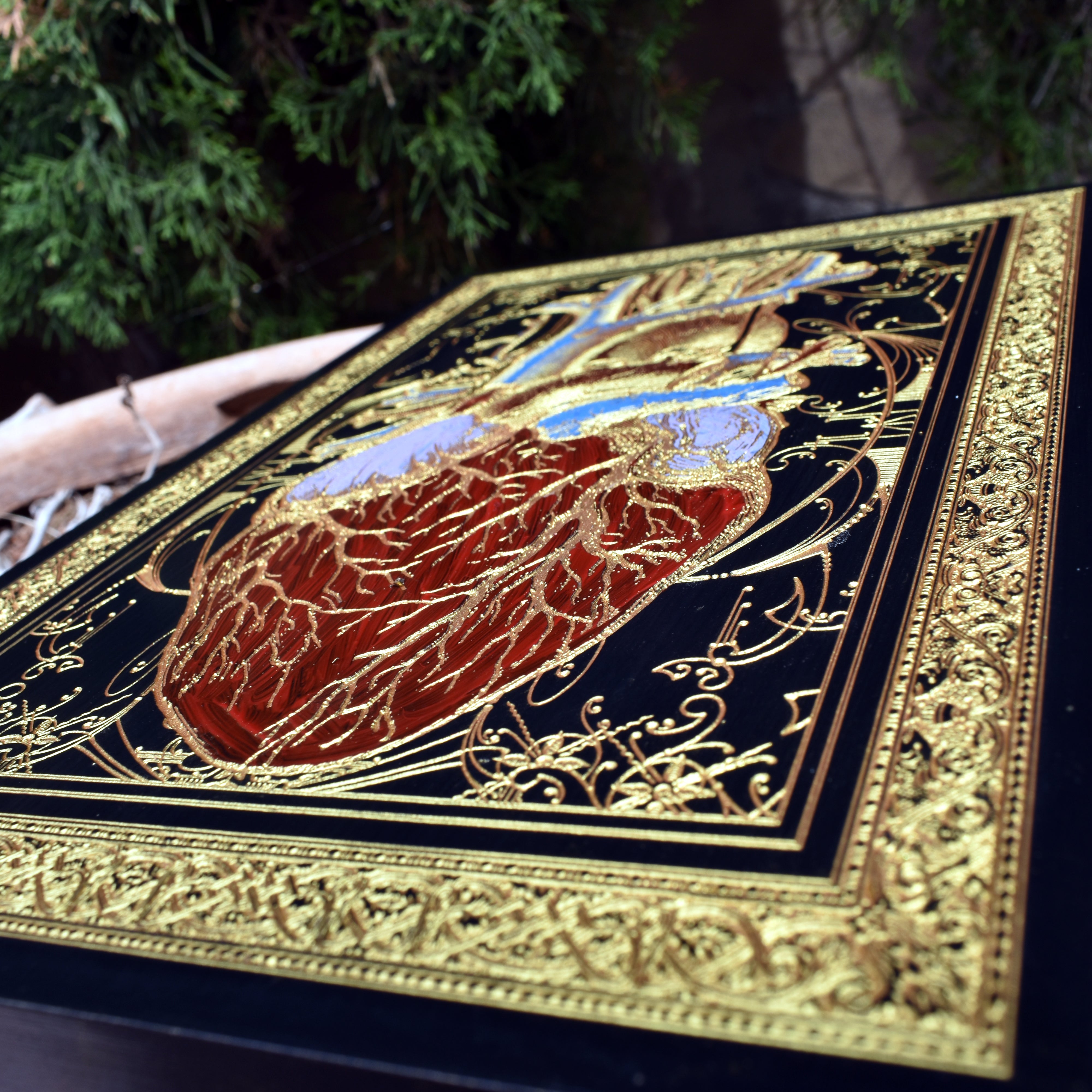 Medical-themed wooden heart engraving in stylish black and gold palette.
