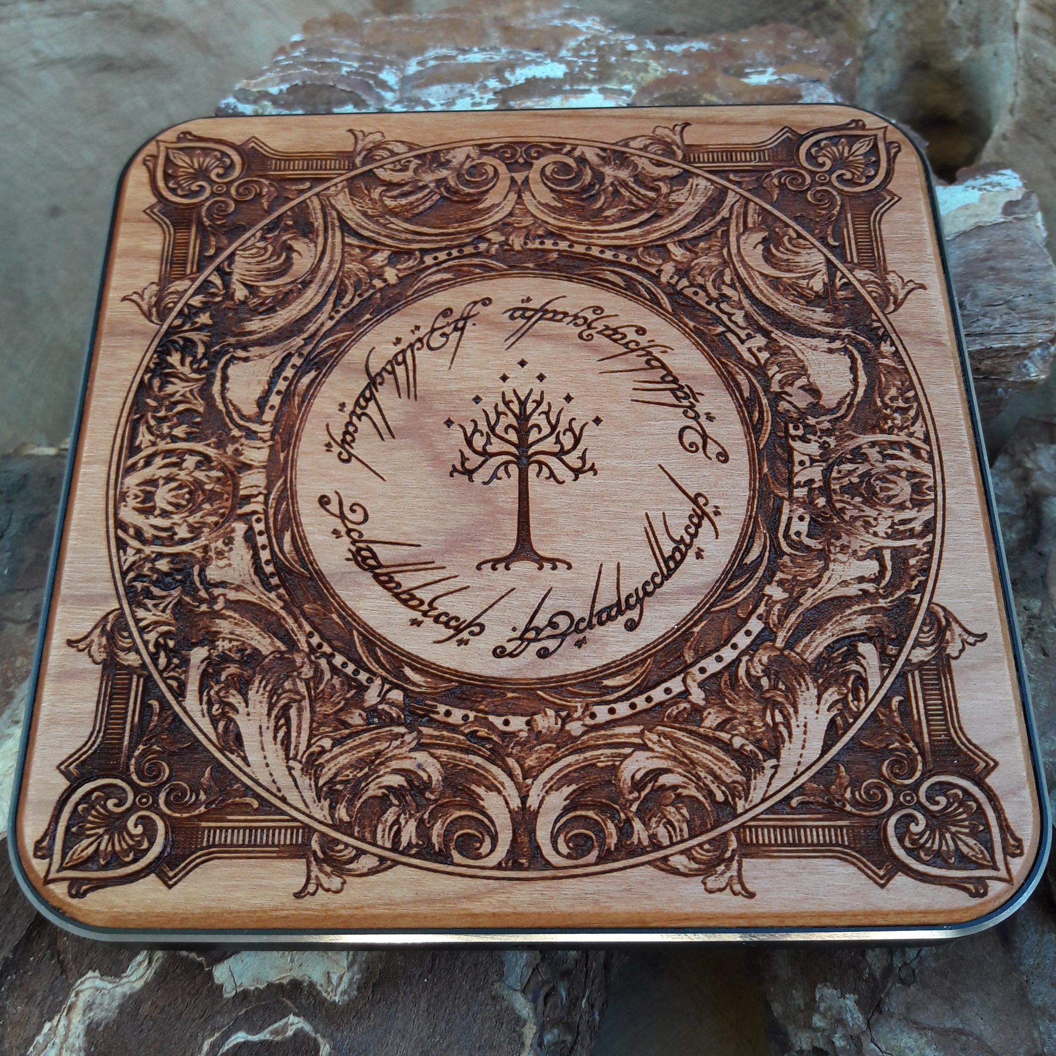Dark wood charger with hand-carved One Ring inscription.