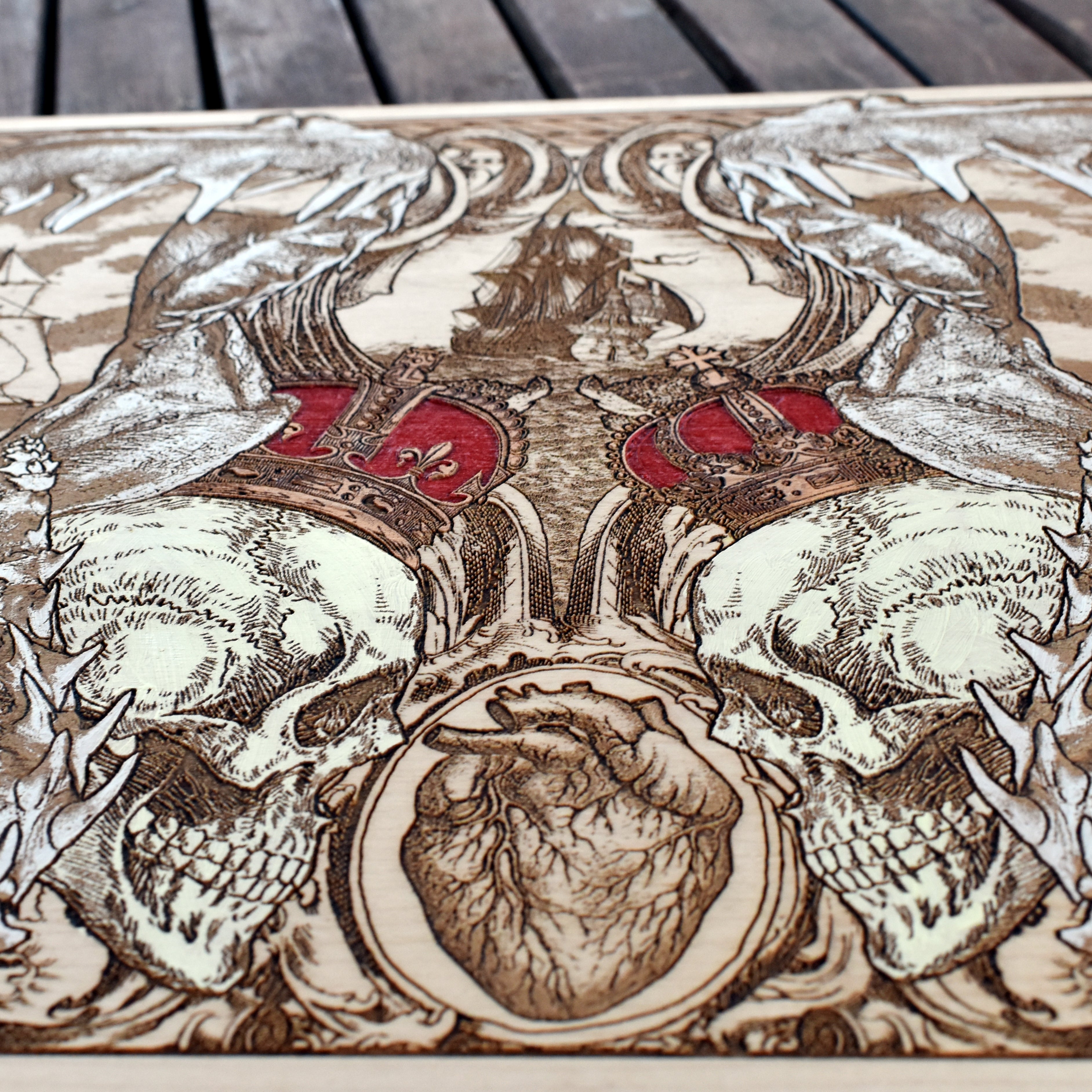 Extra-large shark jaw and pirate ship wood wall art, close-up of the crowned skulls beneath the shark jaws
